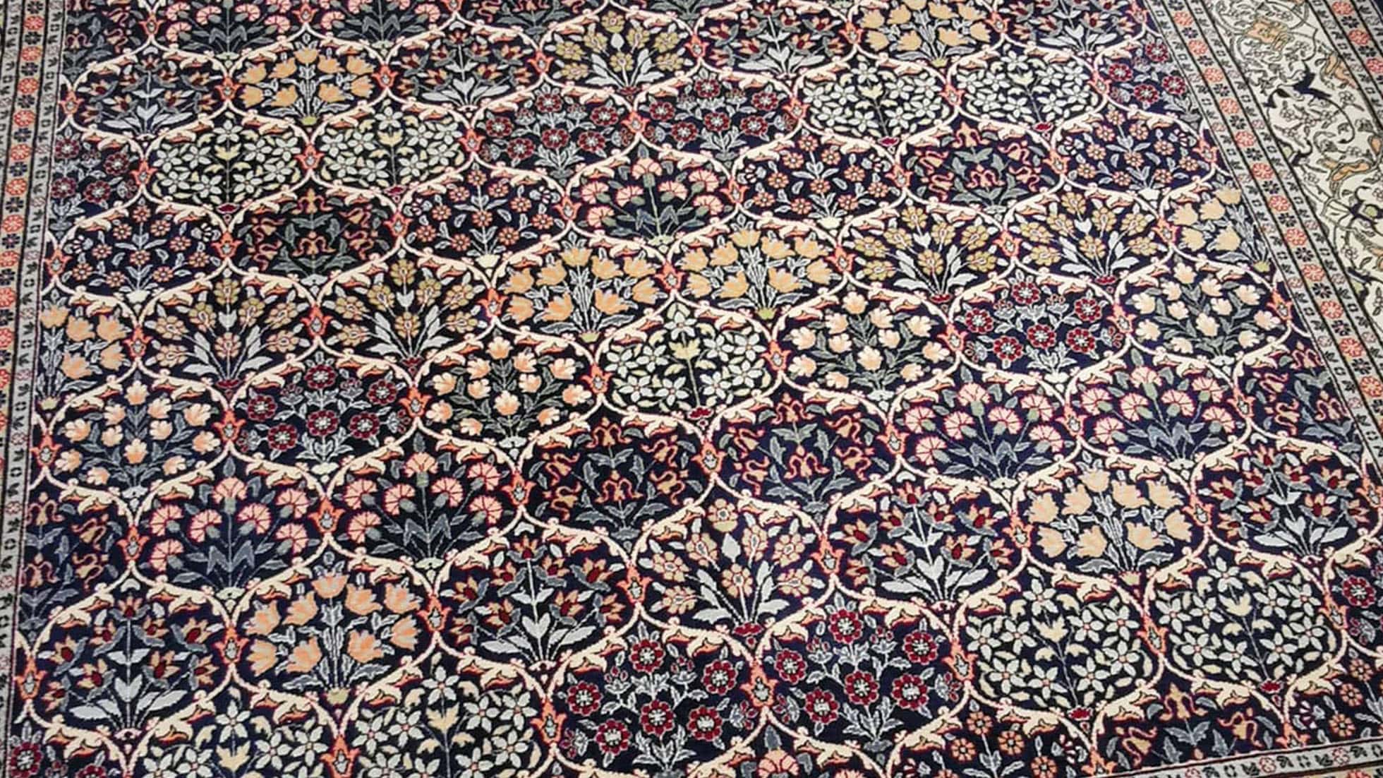 luxury fine antique Turkish Hereke silk rug in pastel, earthy, and neutral floral motifs and patterns
