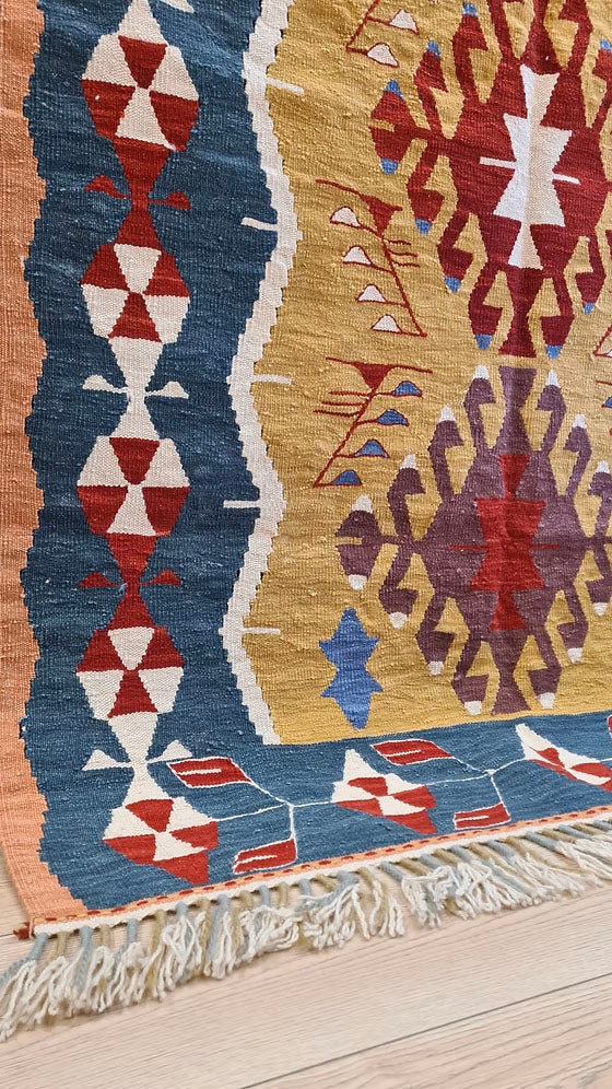 Luxury 4x6 Turkish handwoven kilim rug with geometric design and warm vintage-inspired colors for eclectic or mid-century interiors.
