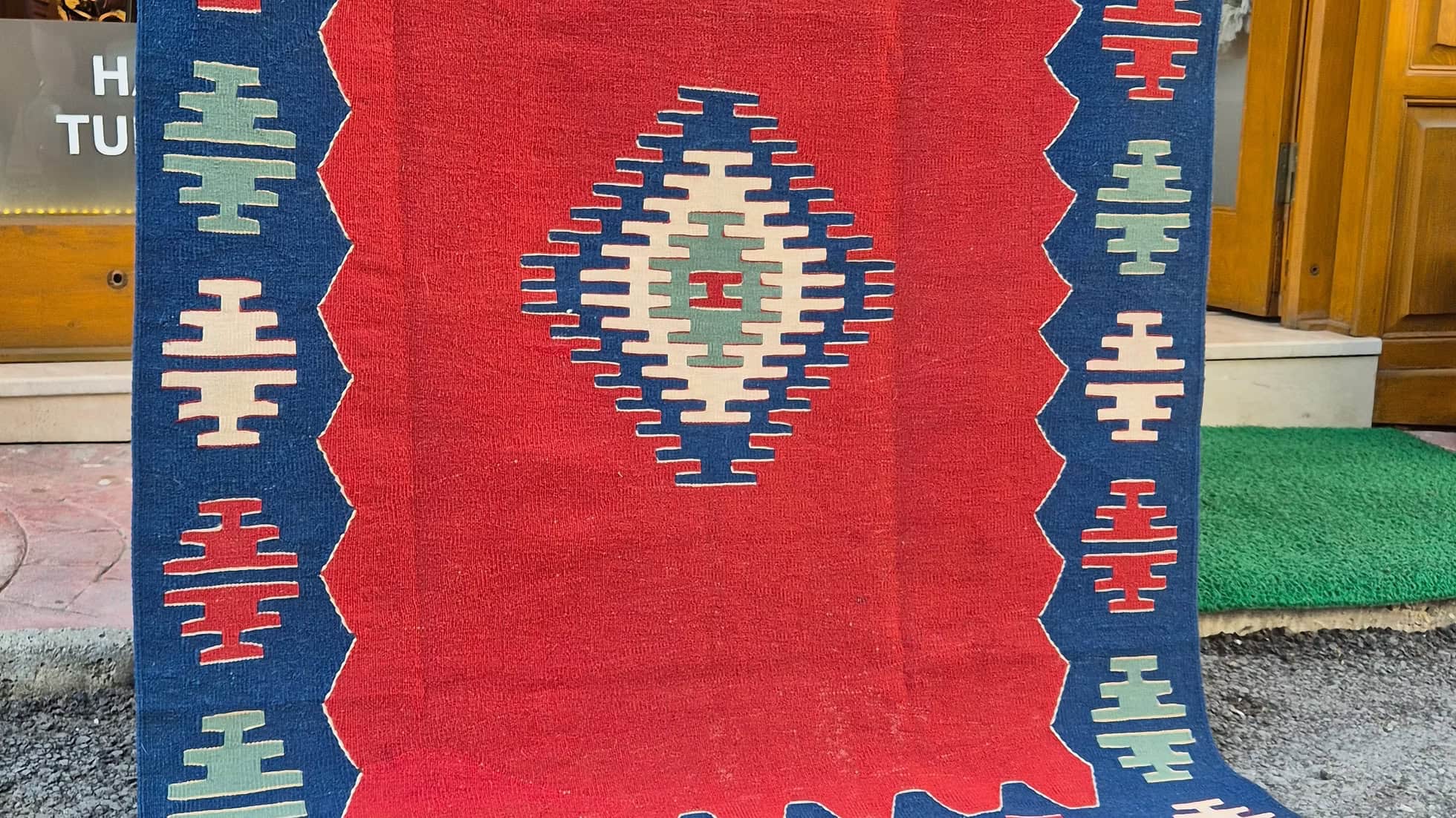 Oushak flat-weave rug by Kilim Couture New York with balanced vermillion red field and abstract geometric medallion