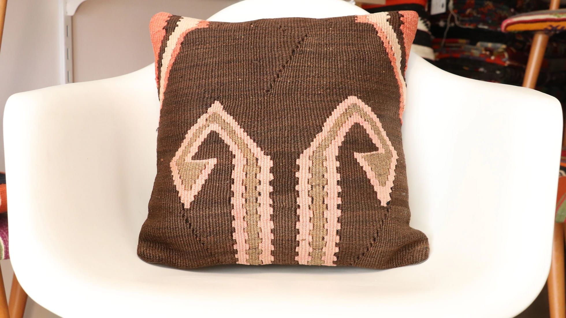 traditional kilim pillow made of vintage turkish rug featuring traditional patterns and rustic earthy colors