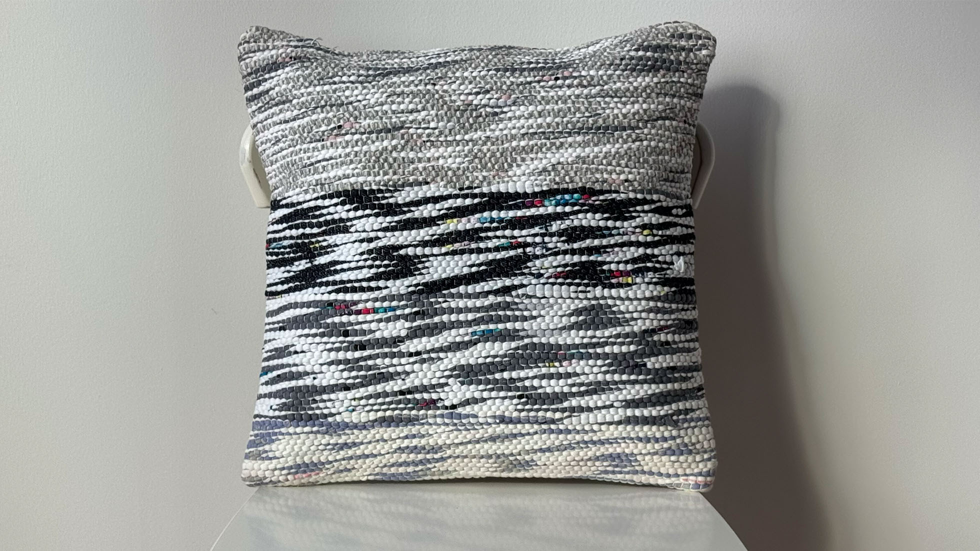 Decorative throw pillow handwoven sustainably from an authentic vintage Turkish chaput kilim, featuring dove grey, crimson red, and black accents, showcasing traditional Anatolian weaving techniques.