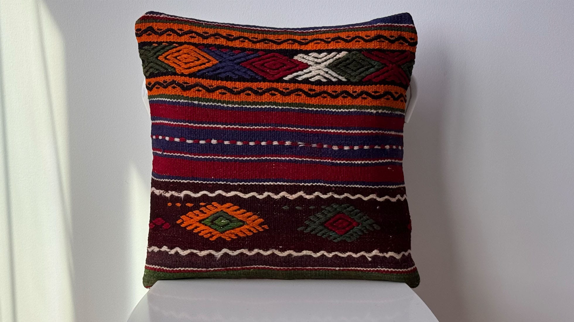 Vintage handwoven Turkish kilim pillow in vibrant orange, green, blue, and black with intricate stripes and dynamic patterns. 16x16 decorative throw pillow, perfect for farmhouse, mid-century, or rustic home decor