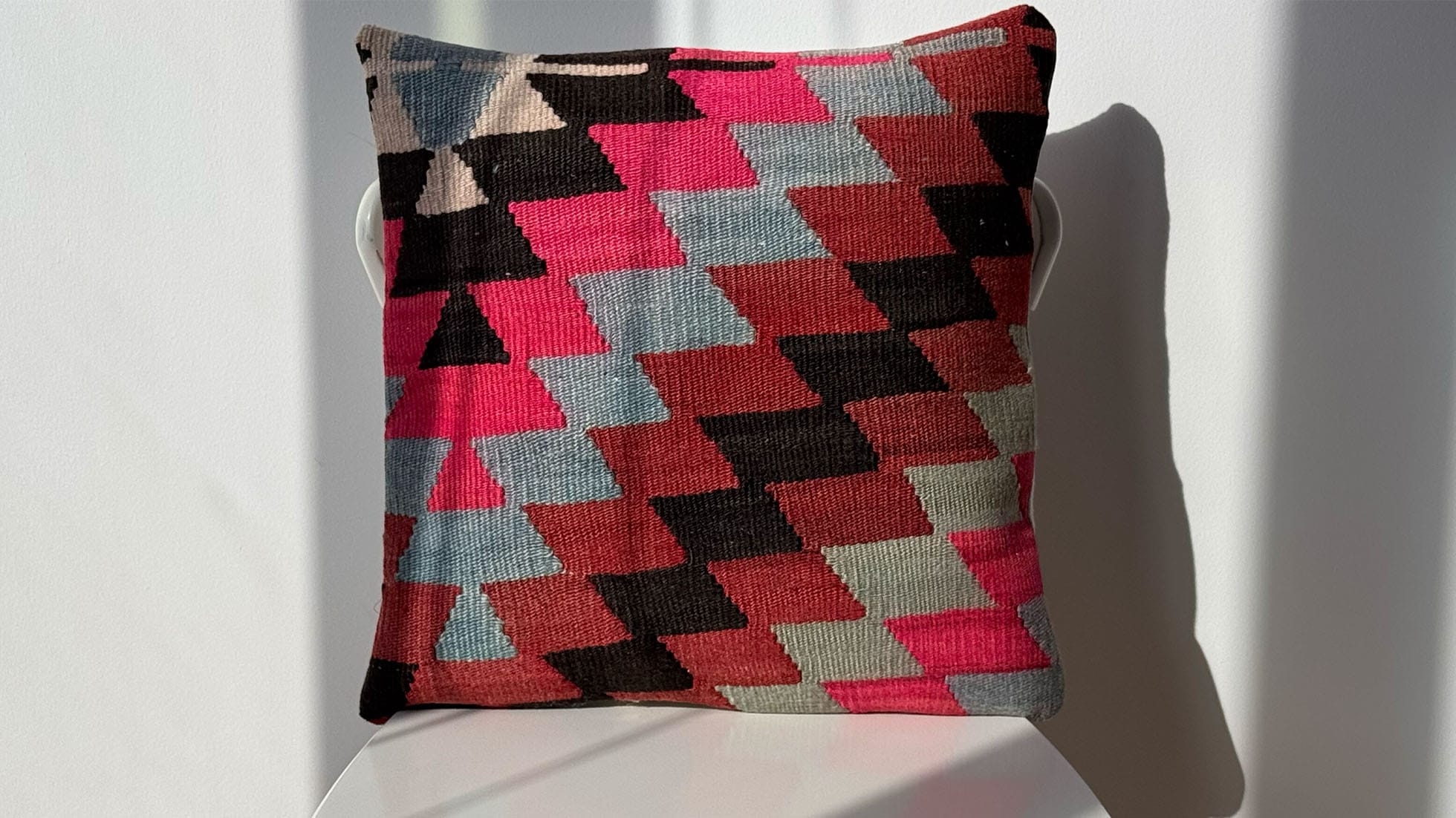 Vintage Turkish Kilim Pillow with zigzag pattern in shades of fuchsia, sky blue, rust-red, and black by Kilim Couture New York