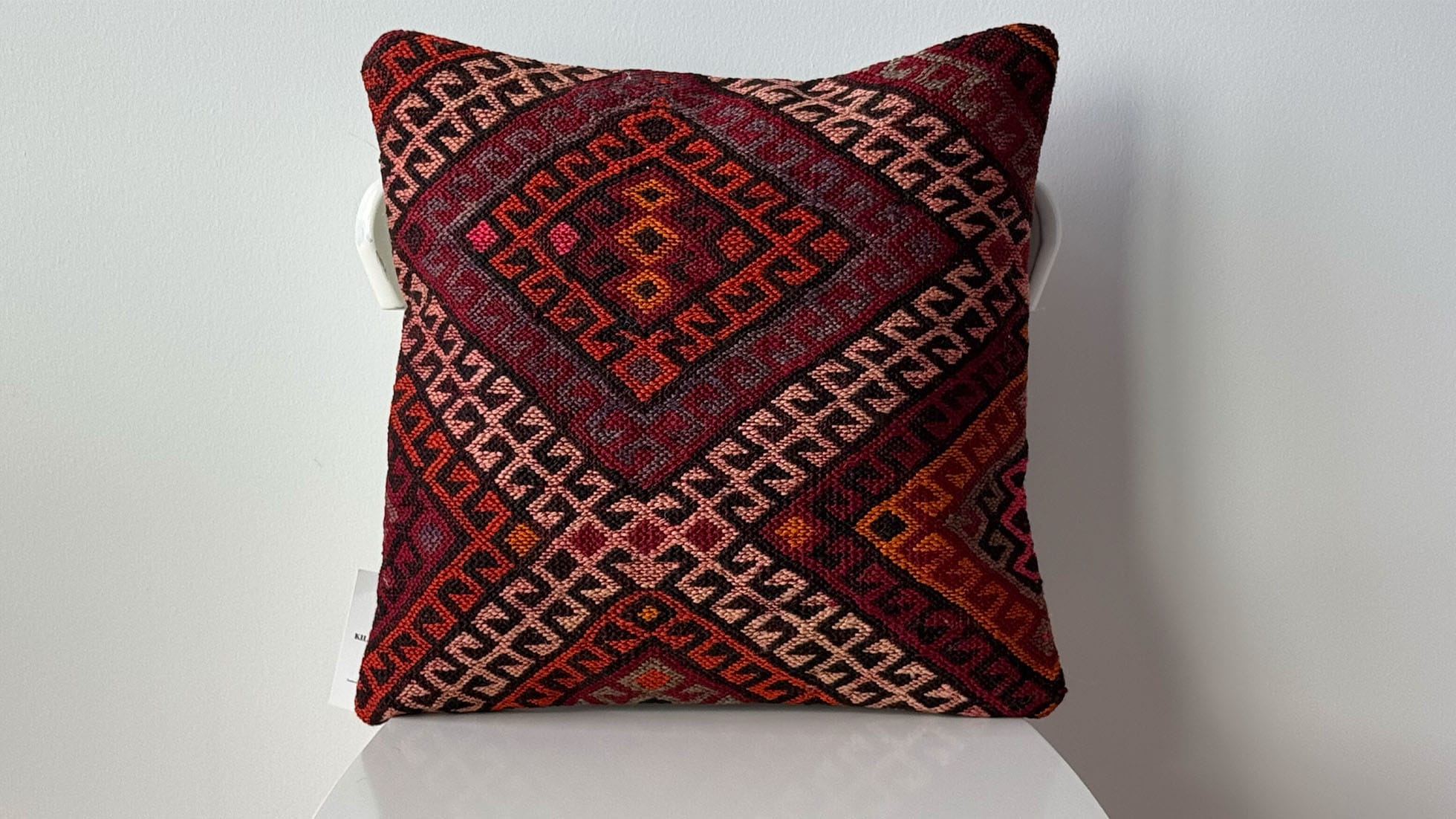 Turkish "Dragon" Kilim Pillow by Kilim Couture New York, handcrafted from a vintage kilim rug featuring intricate amber, crimson, and goldenrod motifs on a garnet background with obsidian and ivory accents.