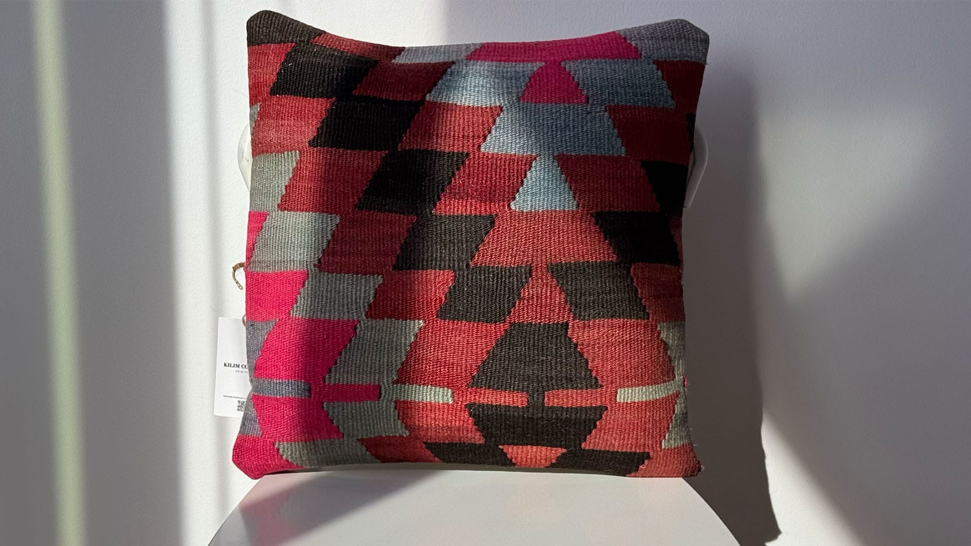 Handcrafted multicolored kilim pillow with intricate geometric patterns, made from sustainable wool and cotton. A luxury decorative throw pillow ideal for modern, boho, and eclectic interiors, adding texture and warmth to any space.