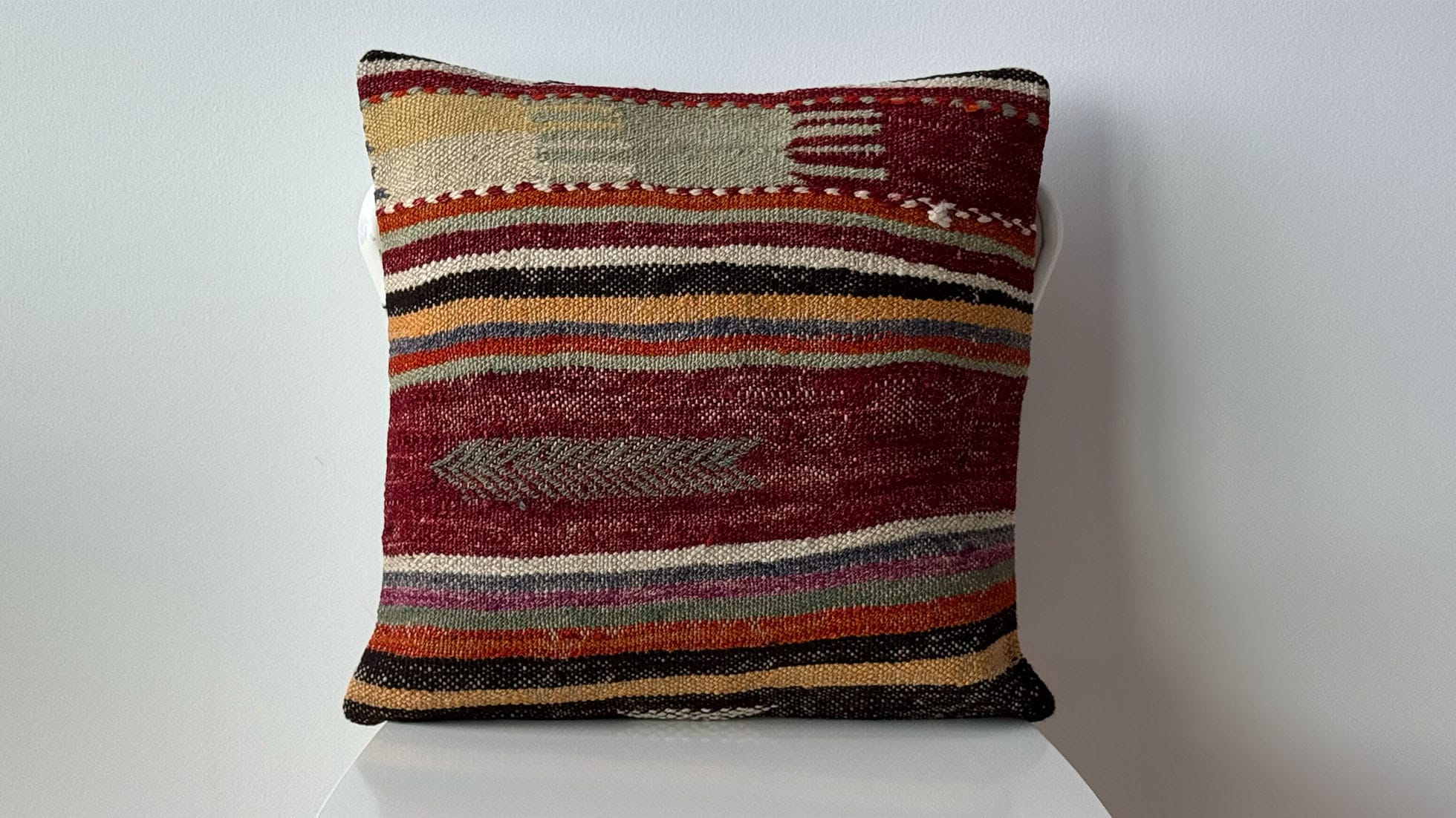 Rustic vintage Turkish kilim pillow in pastel brick, khaki, and soft gray stripes with tribal motifs, 16x16, handwoven by artisans for eco-conscious, high-end interiors