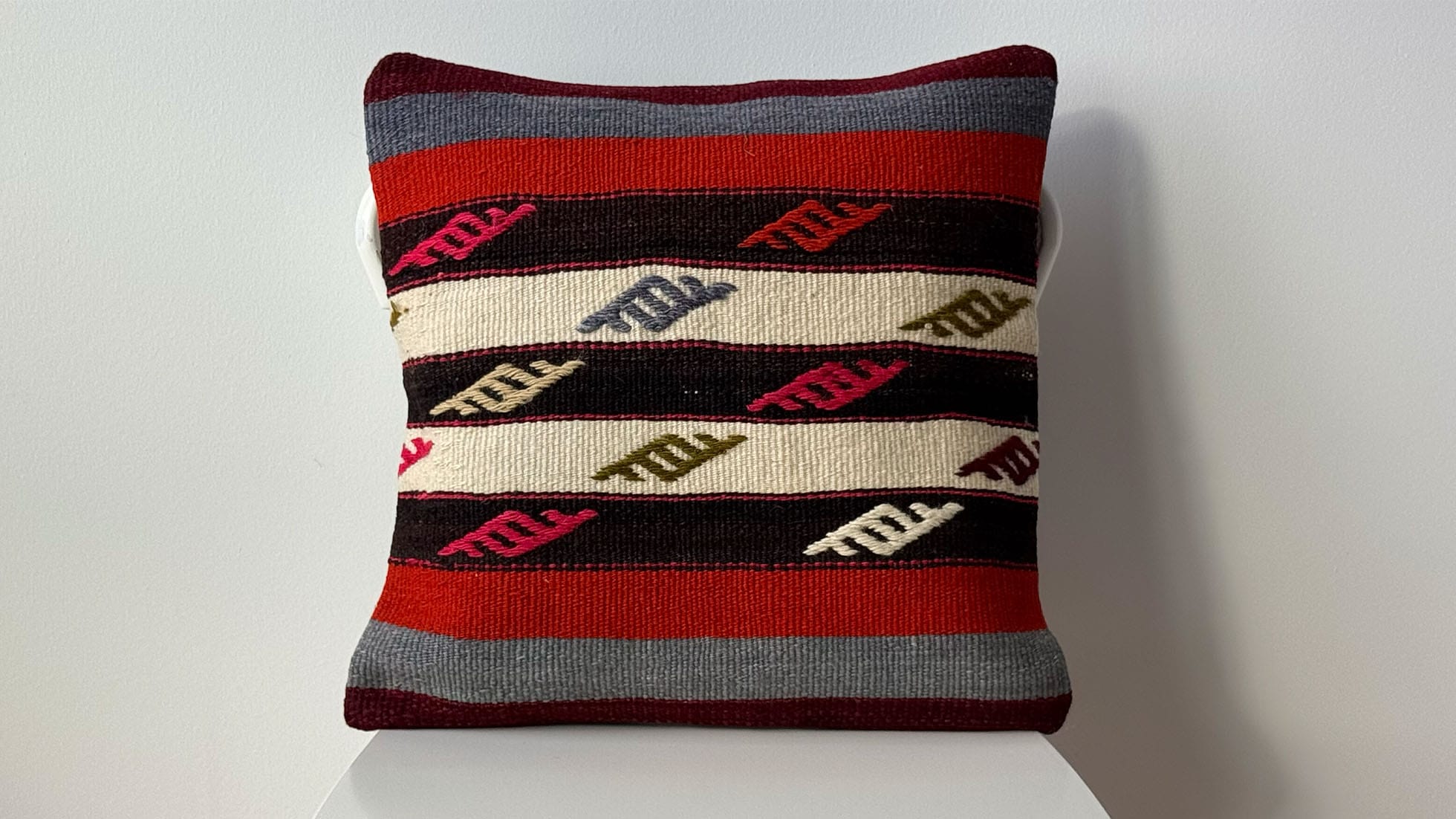 Vintage Handwoven Kilim Pillow with Tribal Motifs and Bold Stripes, a luxurious, artisanal accent crafted from premium materials, perfect for high-end interior design projects.