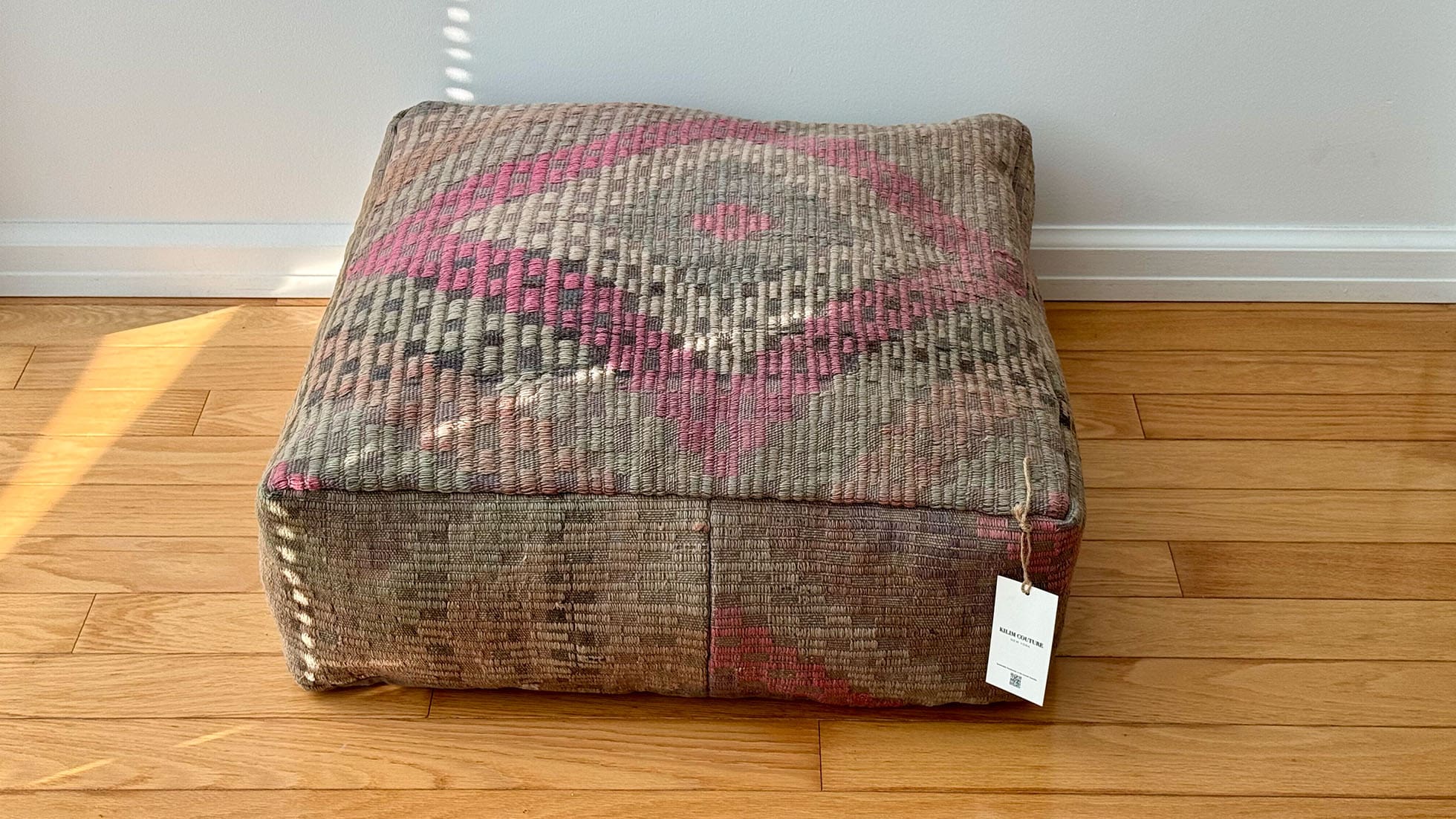 Vintage kilim ottoman pouf by Kilim Couture New York, handcrafted from authentic Turkish kilim fabric using the traditional Cecim technique. Features a pastel pink, taupe, and khaki diamond motif, ideal for bohemian, eclectic, or modern home décor, adding warmth and cultural elegance.