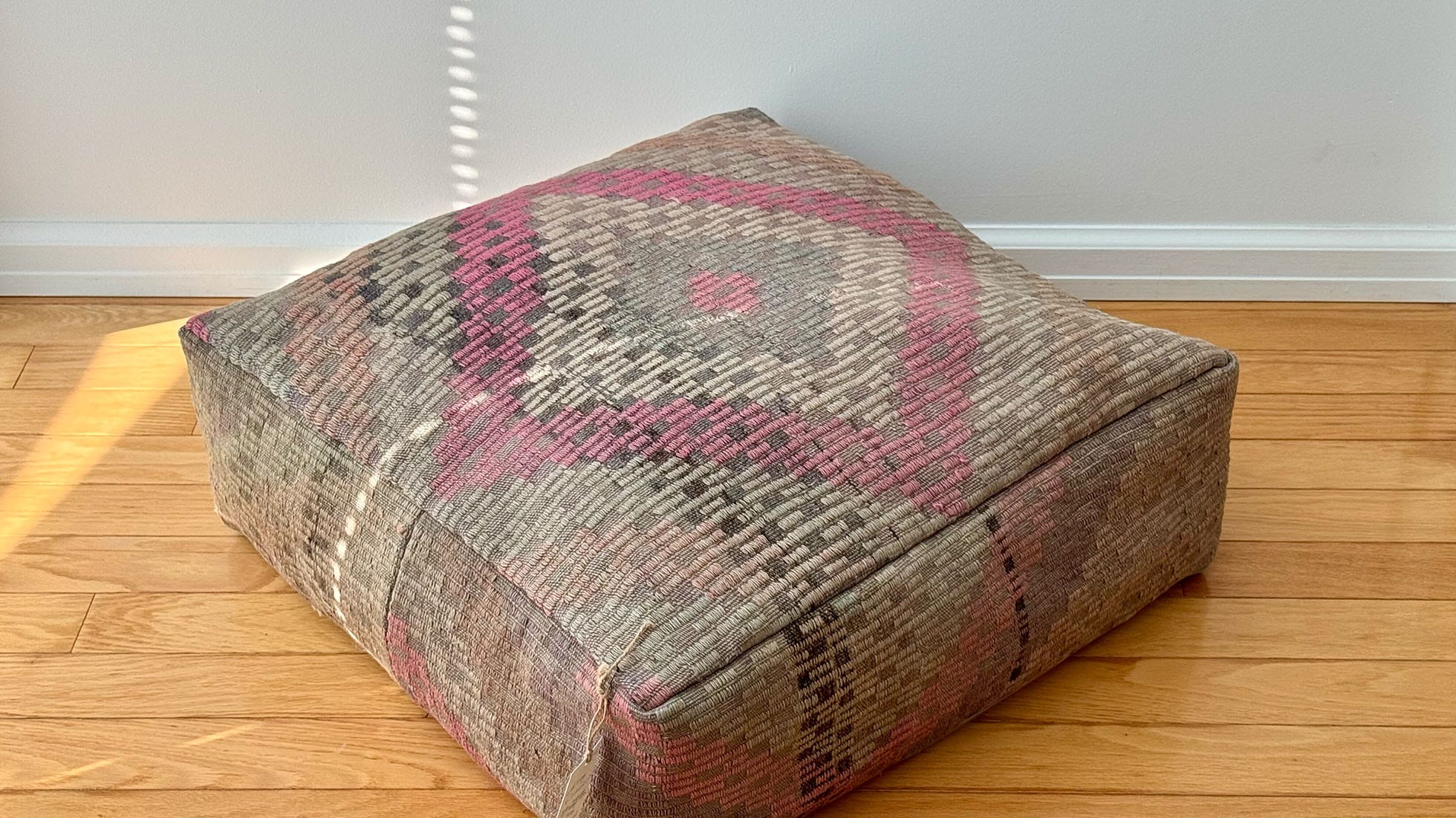 Vintage kilim ottoman pouf by Kilim Couture New York, handcrafted using the traditional Cecim technique, featuring a soft rose, taupe, and sage diamond motif, perfect for adding warmth and cultural elegance to home decor