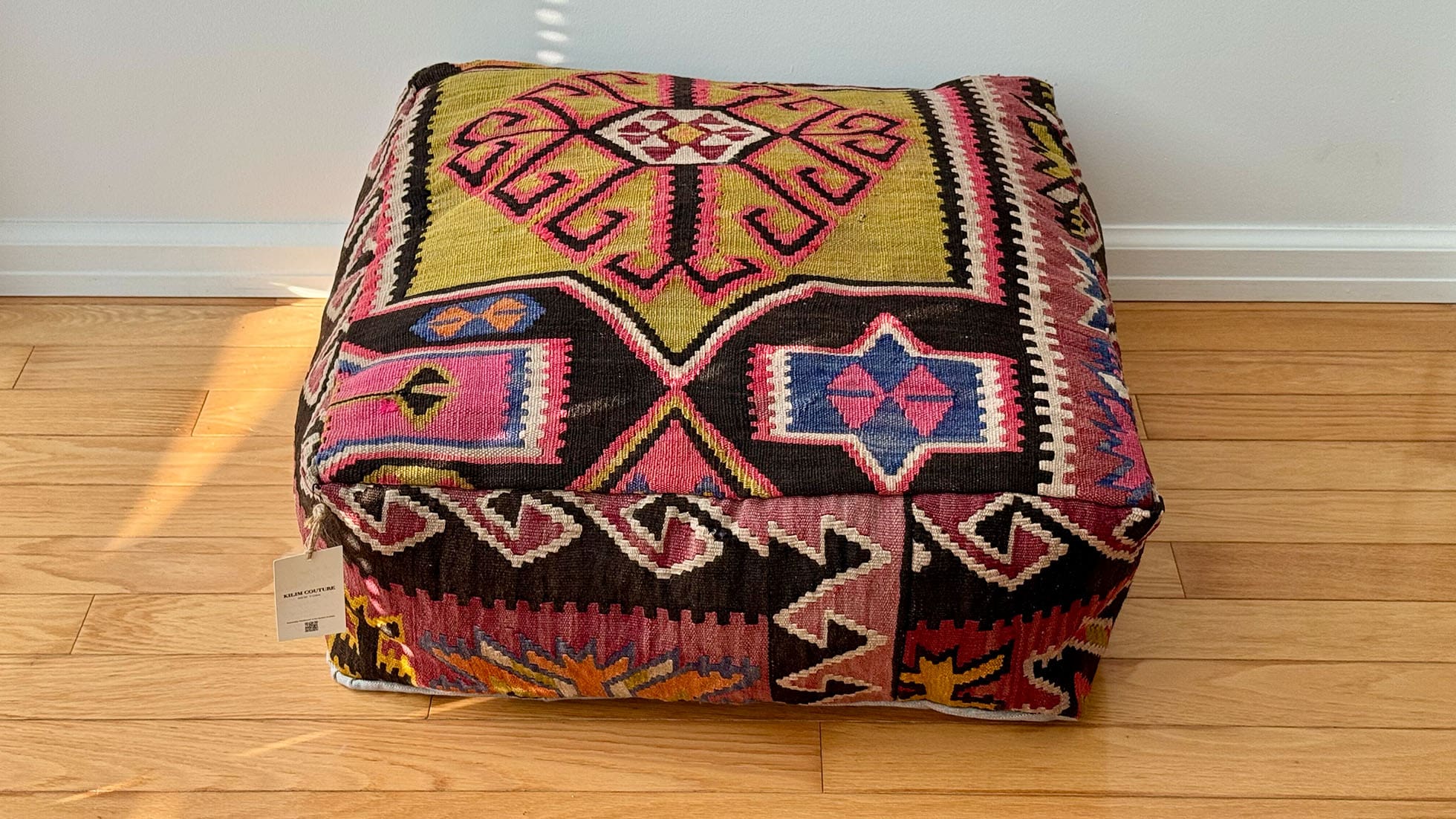 Authentic Turkish Kilim Ottoman by Kilim Couture New York in mustard yellow, coral, and indigo blue with traditional Turkish motifs, handwoven from a genuine kilim rug, perfect for boho, eclectic, modern and rustic farmhouse décor.