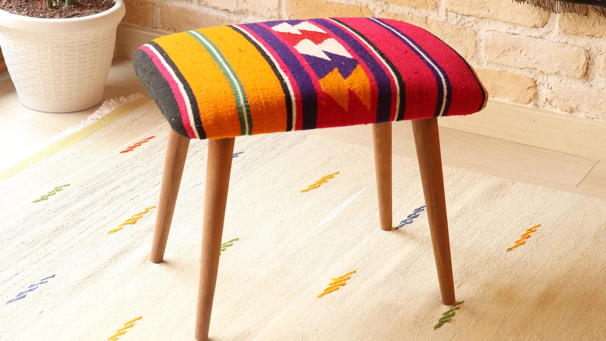 Vintage Kilim Upholstered Stool with Polychromatic Stripes in Tangelo, Fuchsia Fedora, and Amethyst Purple, handcrafted from Turkish kilims, mid-century modern design with removable wooden legs.