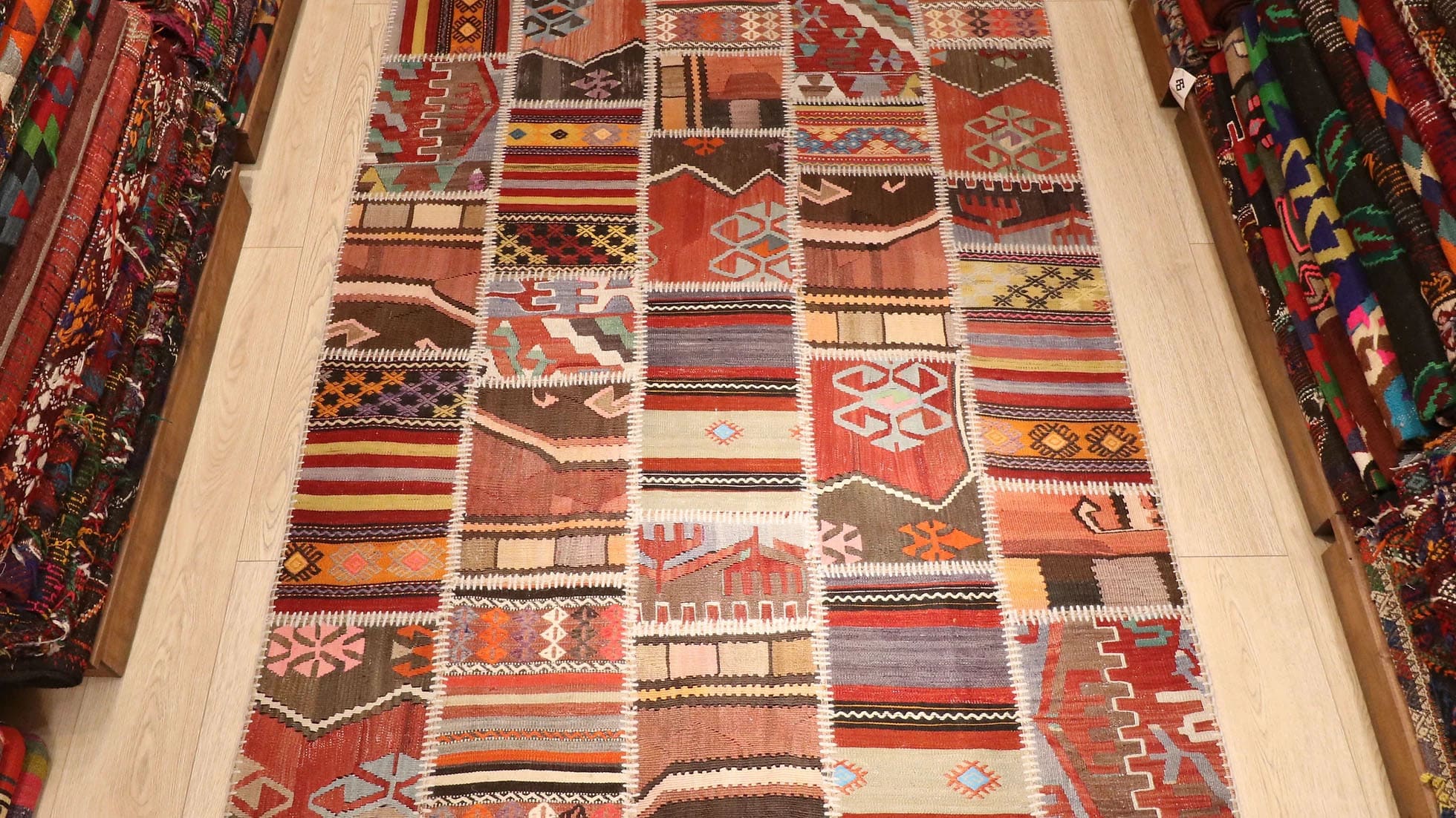 Semi-Antique Handwoven Turkish Patchwork Kilim Rug, 5x6 ft, featuring vibrant polychromatic stripes and intricate patterns. Crafted from vintage kilim patches, each representing different Turkish regions, offering a unique, cultural narrative in a modern design.