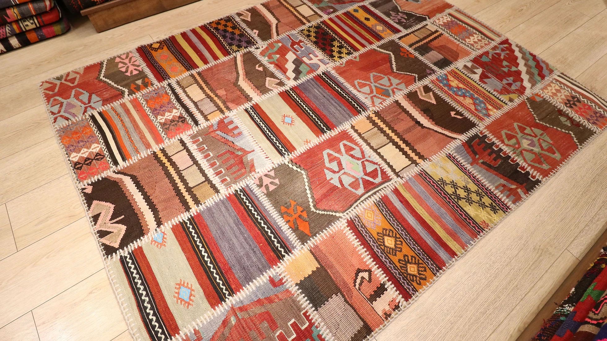 Semi-Antique Handwoven Turkish Patchwork Kilim Rug, 5x6 ft, featuring vibrant polychromatic stripes and intricate patterns. Crafted from vintage kilim patches, each representing different Turkish regions, offering a unique, cultural narrative in a modern design.