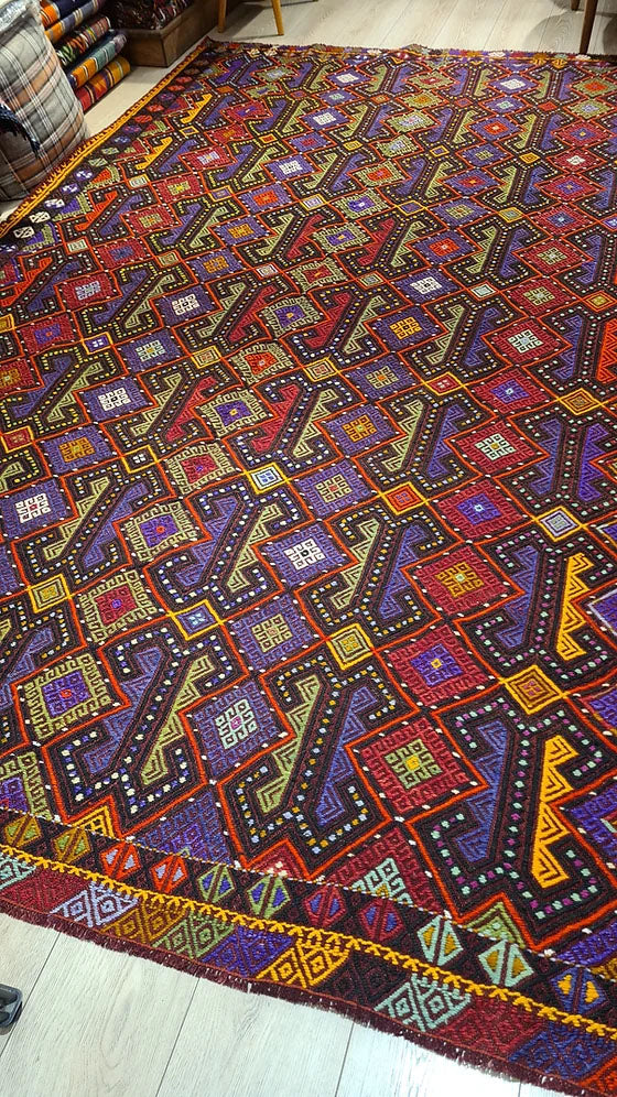 Handcrafted 1960s Turkish wool kilim rug in bold purple, orange, and green hues, available at Kilim Couture New York