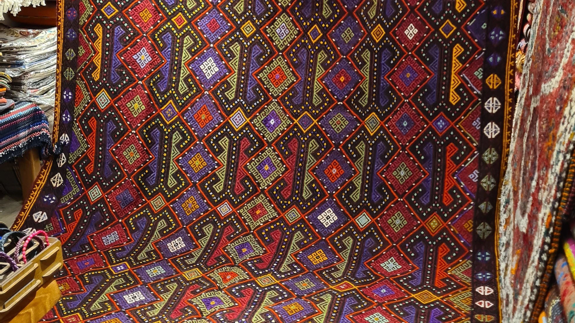 Vintage 1960s cecim handwoven Afyon rug from Kilim Couture New York with rich aubergine, tangerine, and olive tones.