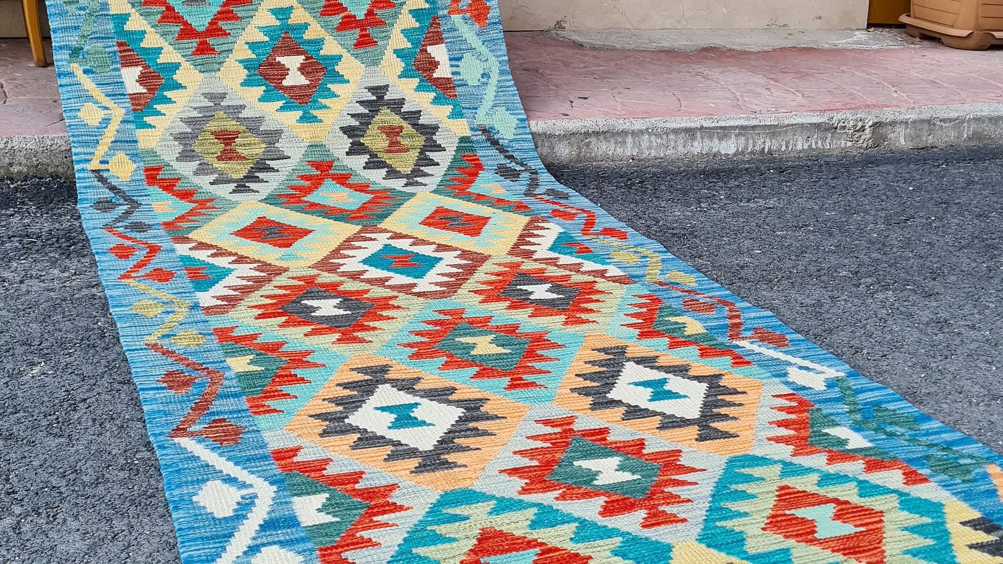 Vintage Afghan handwoven runner with coastal diamond flat-weave design in blue, gray, ivory, and red accents for modern and coastal interiors.