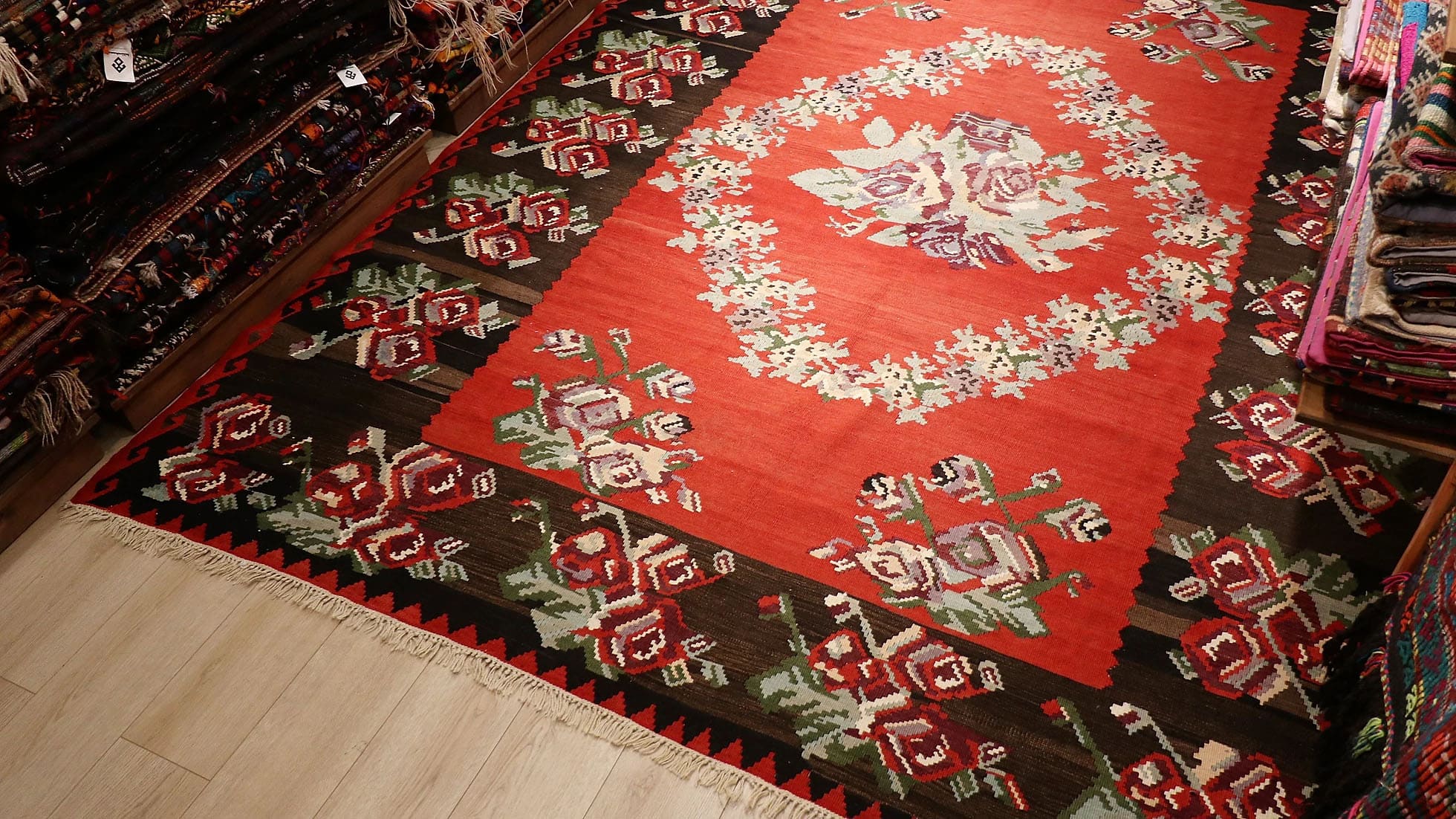 Vintage Moldavian Bessarabian Rug, 8x10 ft. This handwoven treasure showcases a deep crimson backdrop adorned with intricate floral bouquets in lavender, cream, sage, and aqua. Perfect for eclectic or bohemian interiors, its timeless European design adds character and warmth to any space.