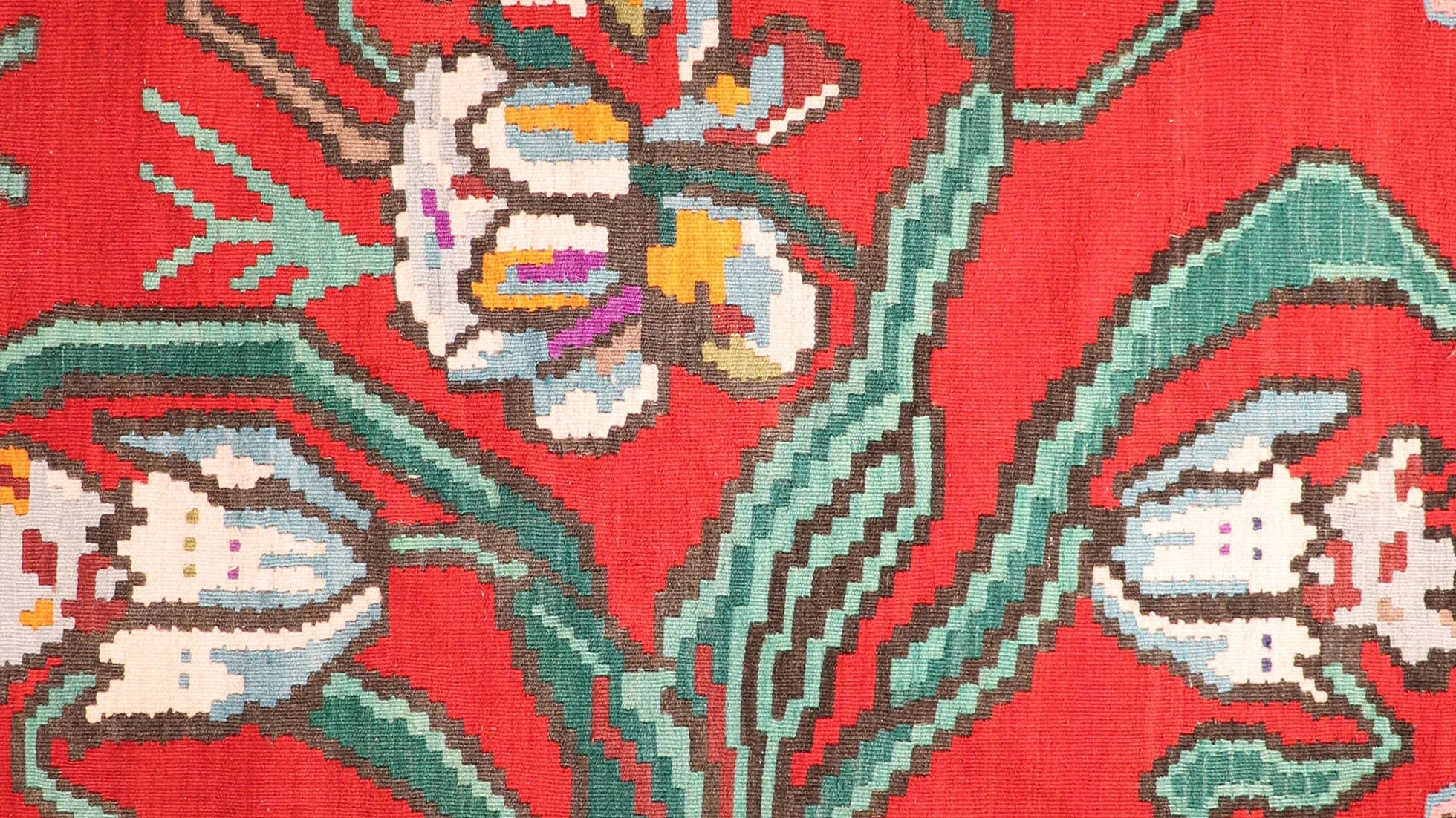 Handwoven vintage Bessarabian kilim rug, 5x7 ft, with a bold oriental red backdrop featuring intricate floral bouquets in cream, aqua green, purple, and lush green foliage, framed by a faded black border with floral accents, showcasing mid-20th century craftsmanship and European elegance.