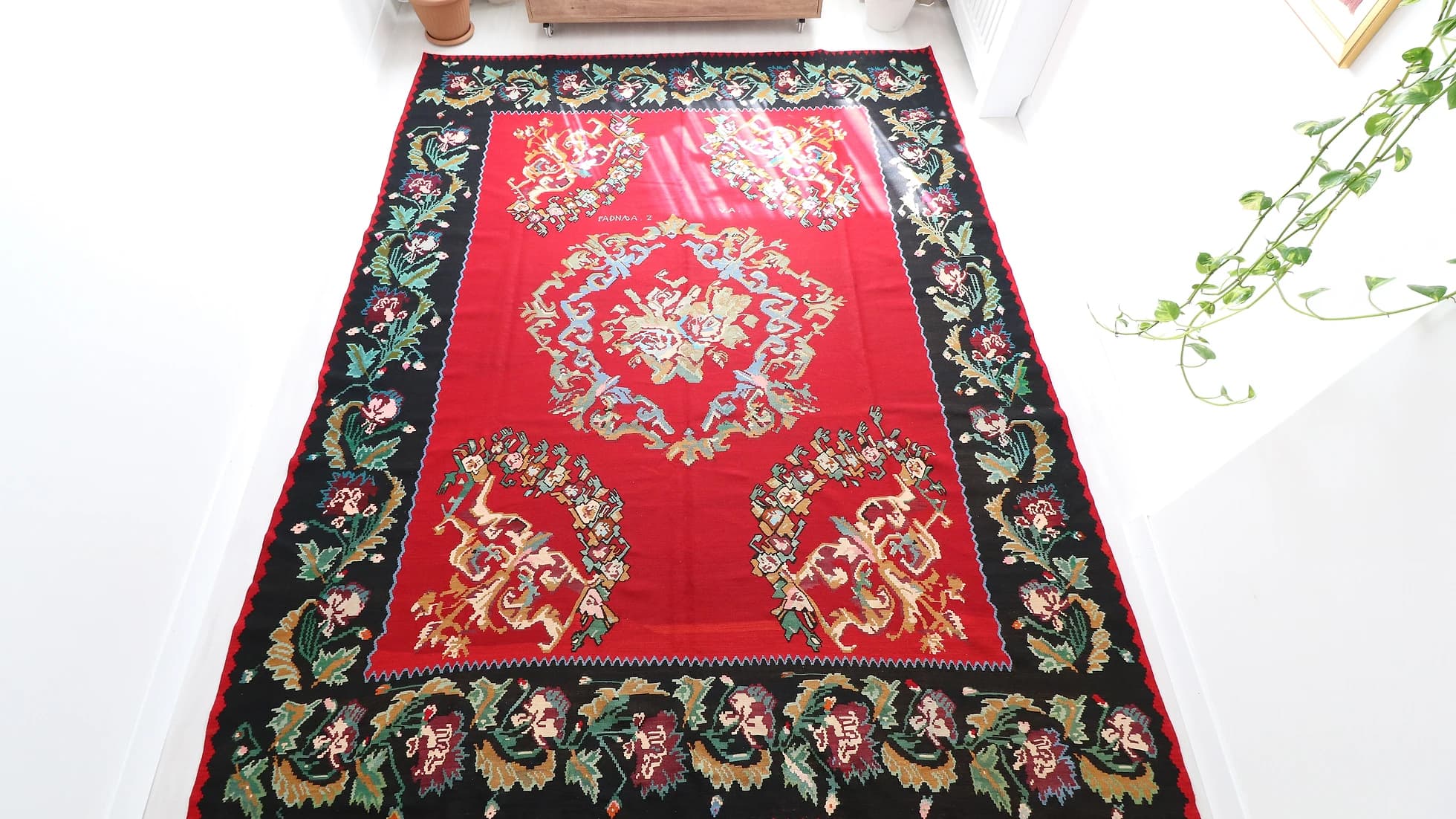 Vintage Hand-knotted Bessarabian Rug in red shades with floral design signed by the artisan