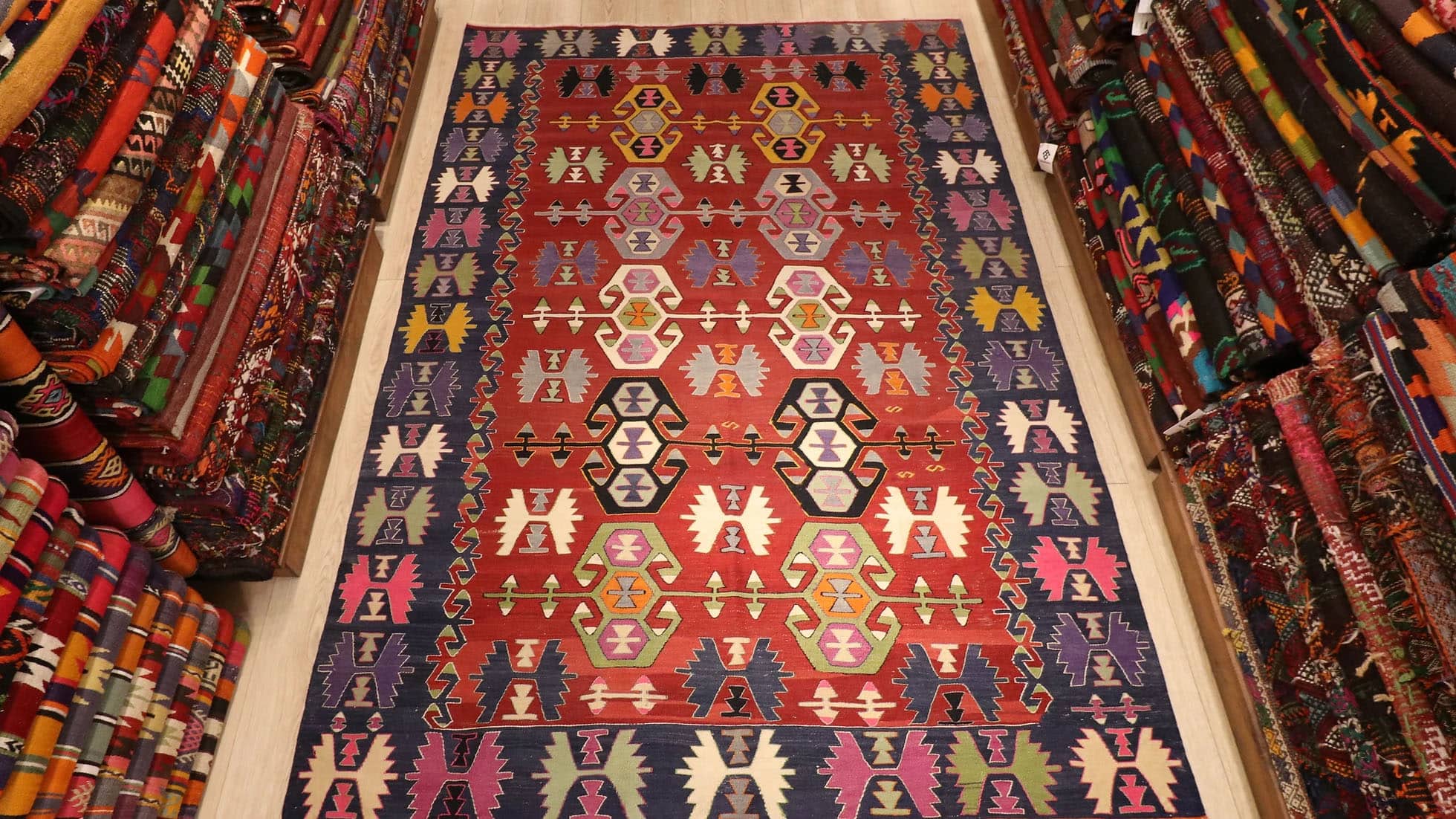 beautiful nomadic tribal flat-woven rug from Denizli, Turkey in red and blue geometric traditional motifs