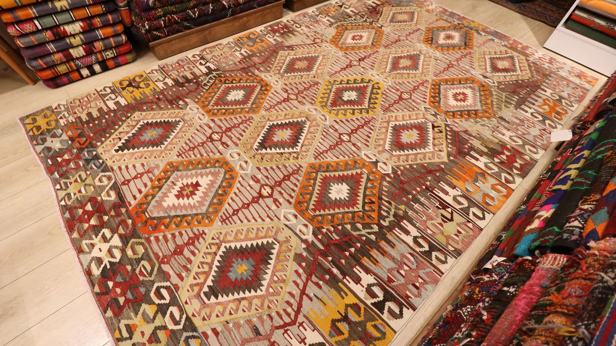 vintage handwoven Turkish rustic kilim rug in muted neutral hues and tribal motifs by Kilim Couture New York rug gallery