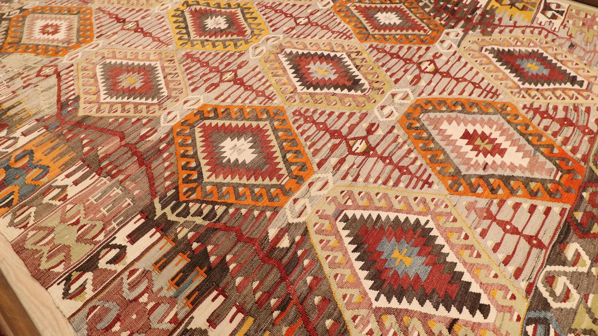vintage handwoven Turkish rustic kilim rug in muted neutral hues and tribal motifs by Kilim Couture New York rug gallery