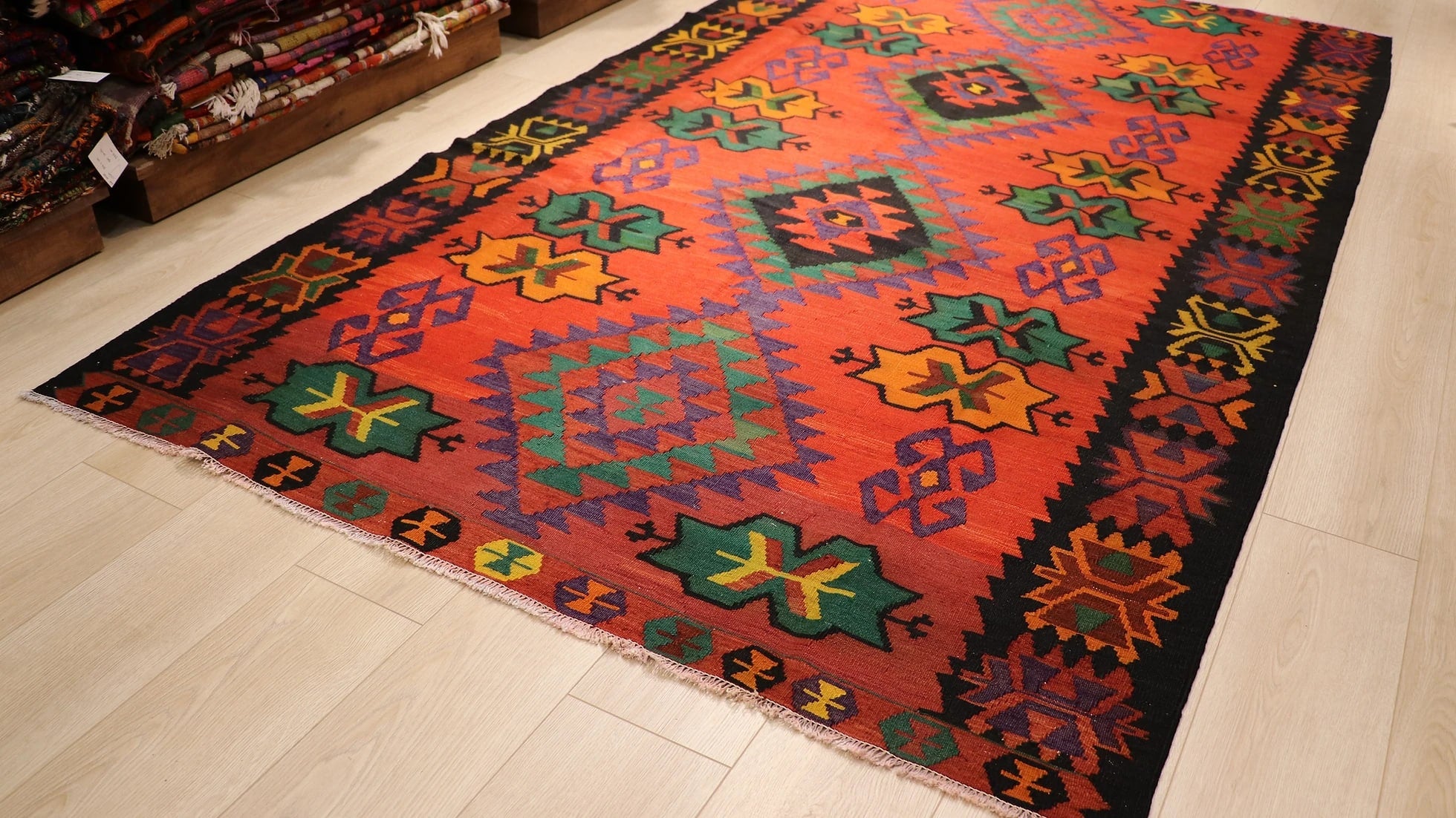 1960s handwoven Caucasian oriental carpet in red, black, and green with star medallions