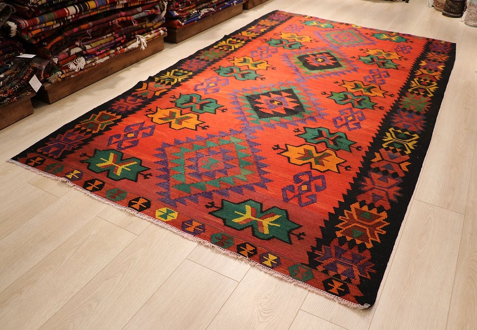 1960s handwoven Caucasian oriental carpet in red, black, and green with star medallions