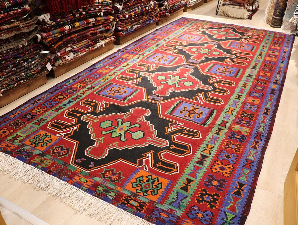 very fine and rare Caucasian gallery runner rug showcasing many traditional motifs and charming geometric medallion patterns in red, black, green, and blue