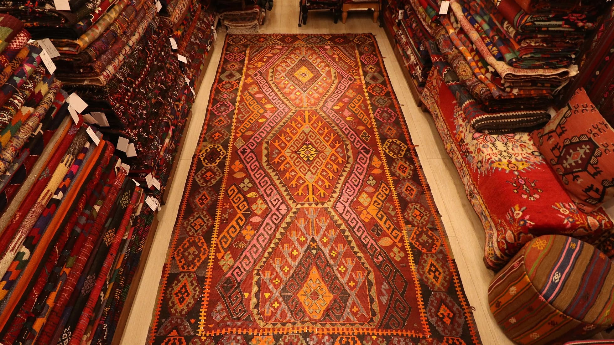 vintage oushak tribal flat-weave rug in earthy pink, red, orange and yellow tones