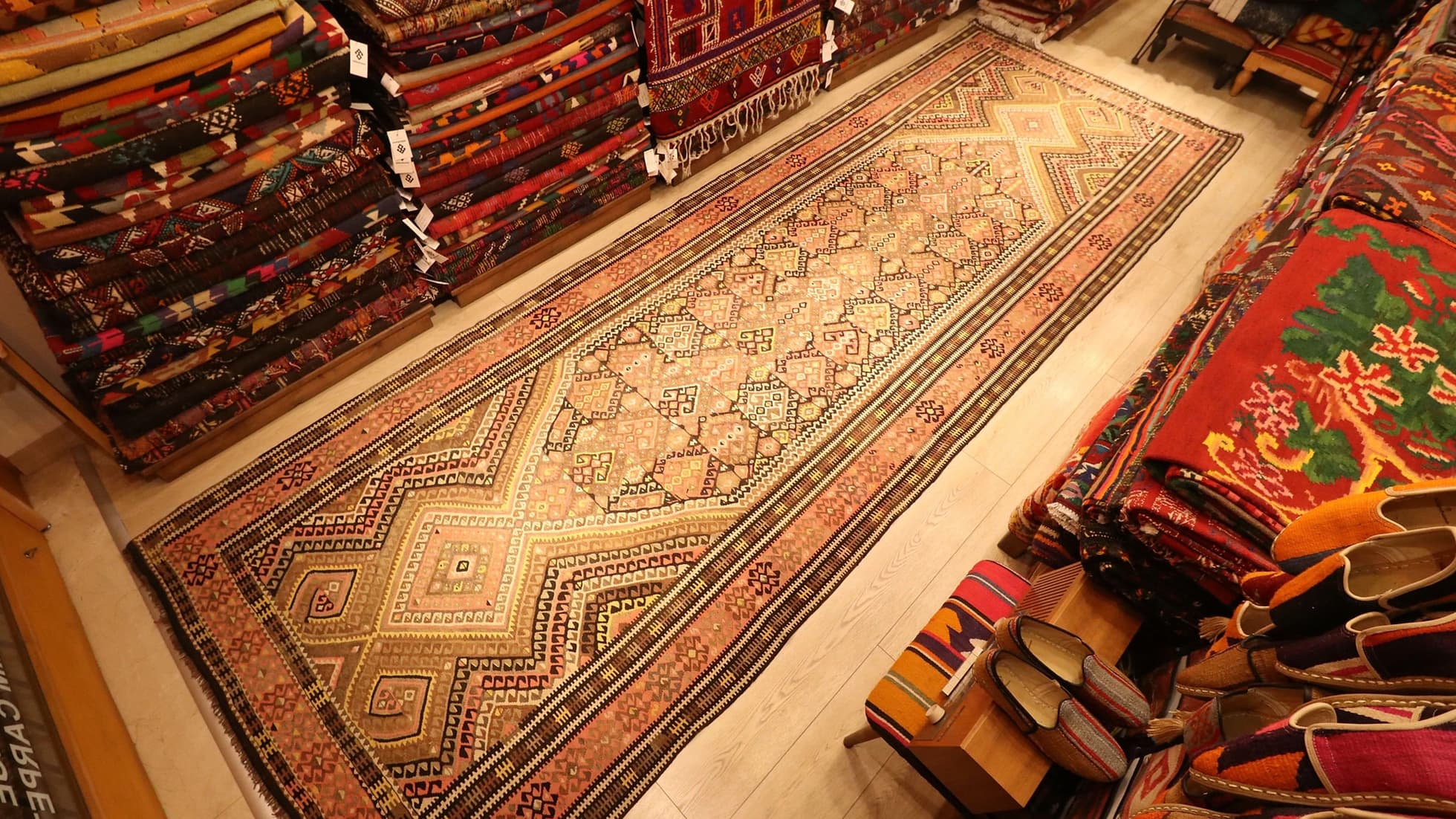 traditional Oushak runner Kilim Rug is displayed in a rug store in NYC