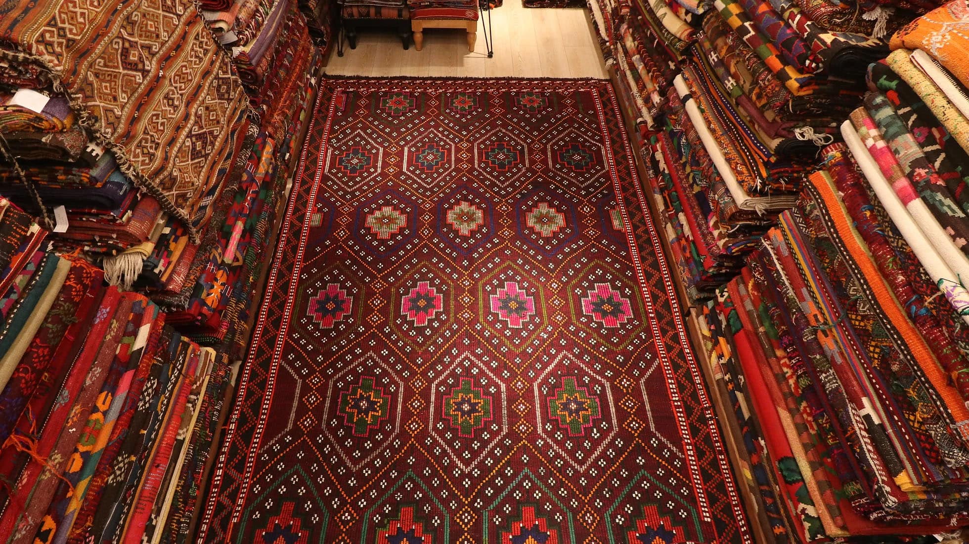 gorgeous red oriental Kurdish kilim rug in pink floral patterns by Kilim Couture New York