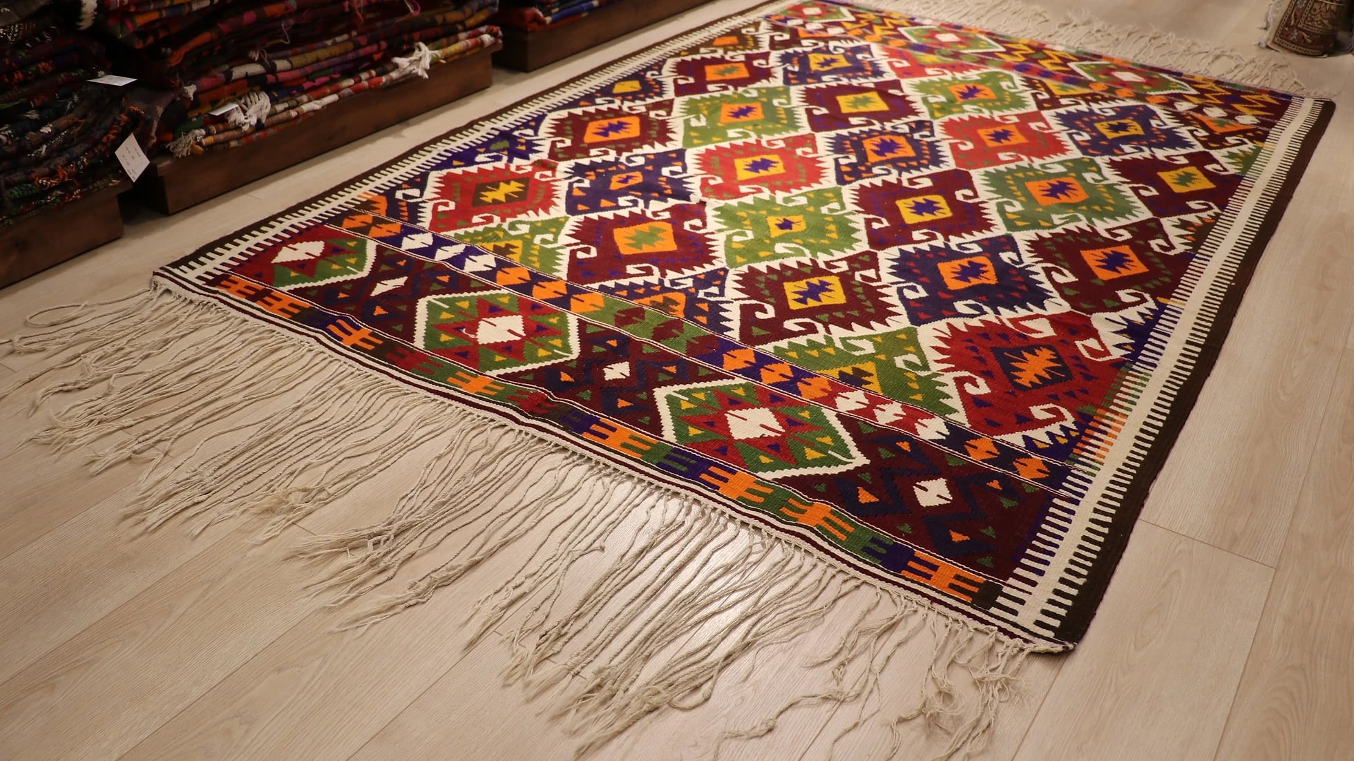 a luxury nomadic handwoven vintage Turkish kilim rug from Antalya in rustic earth tones and tribal motifs