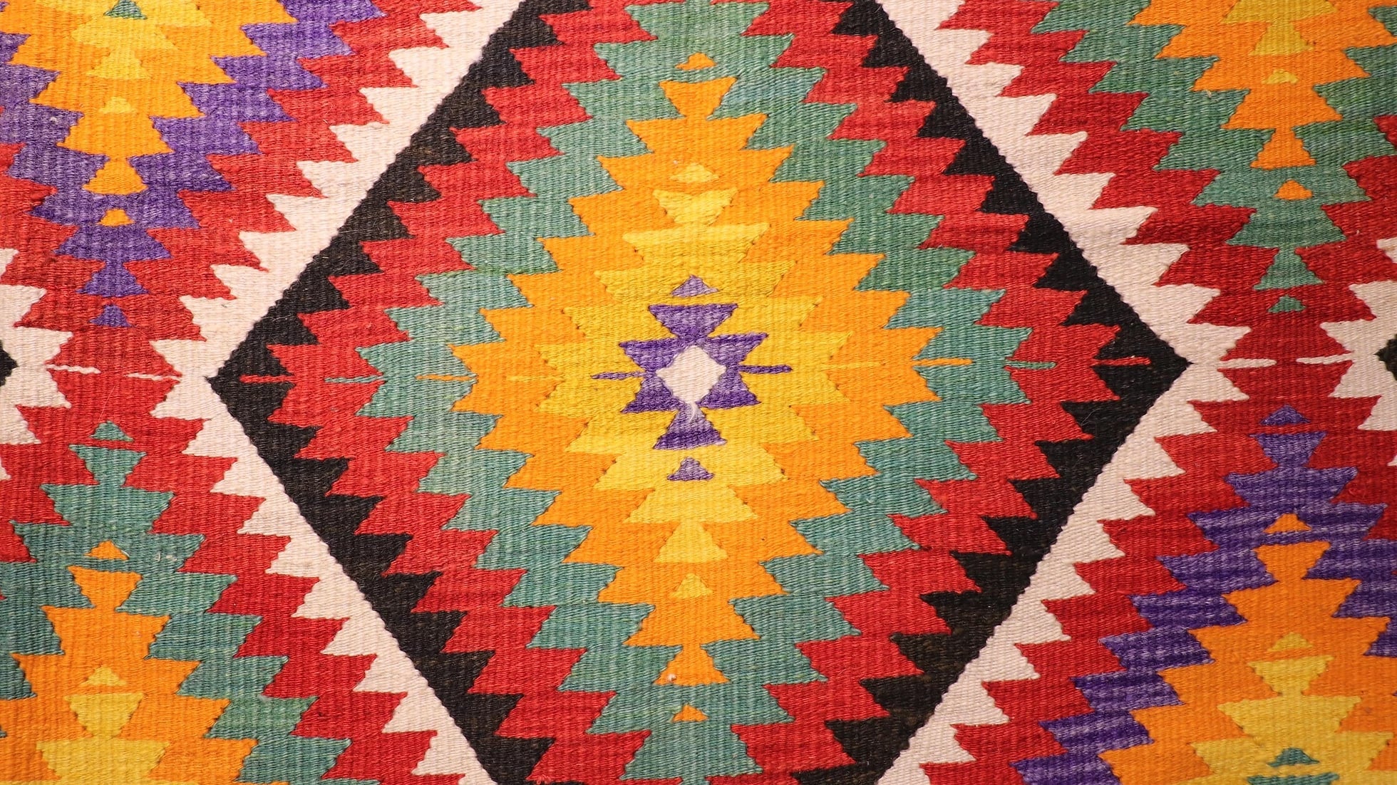 details of vintage turkish hand-knotted contemporary flat-weave rug in colorful diamond patterns