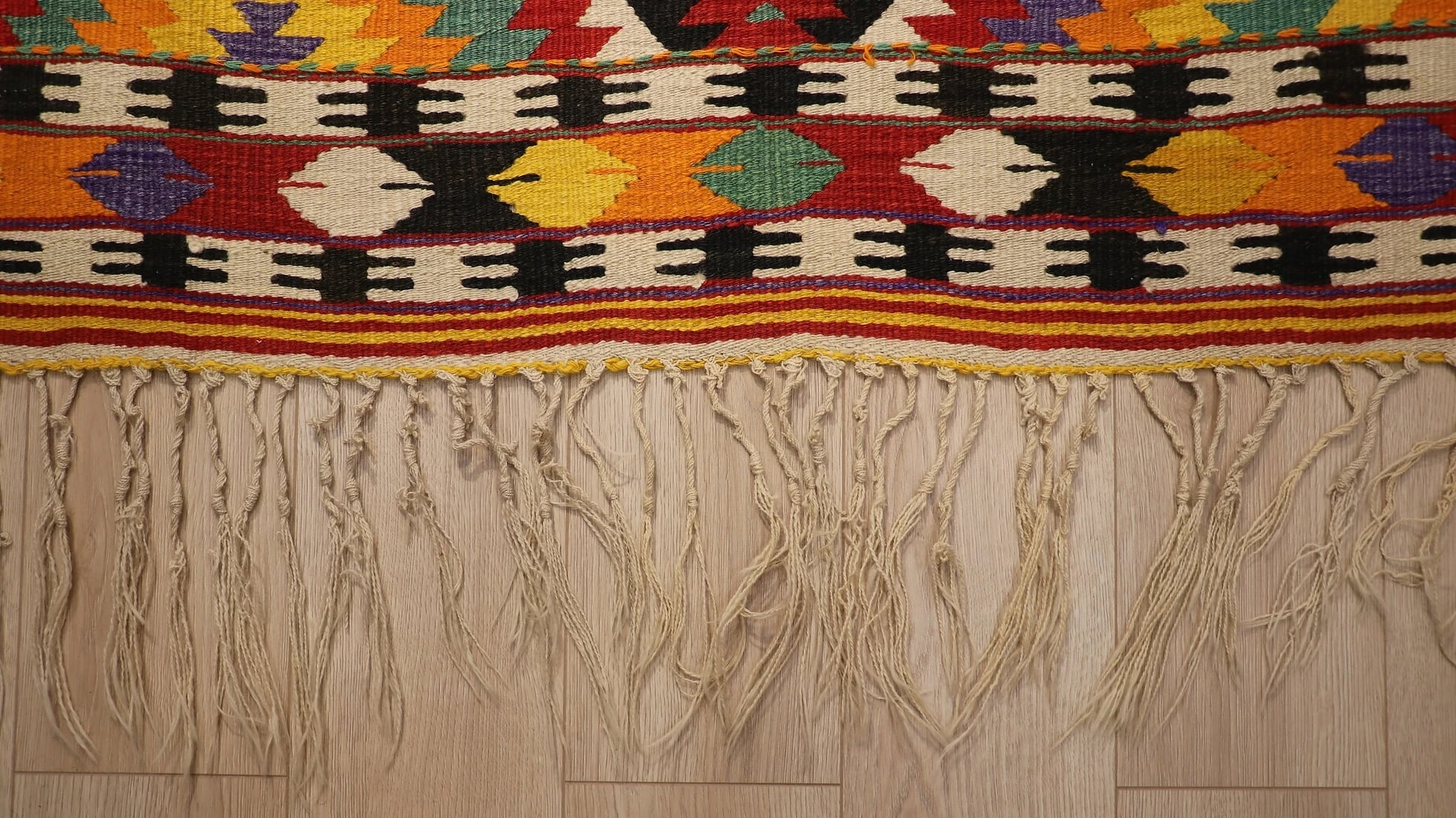 tassels of vintage handwoven contemporary kilim rug