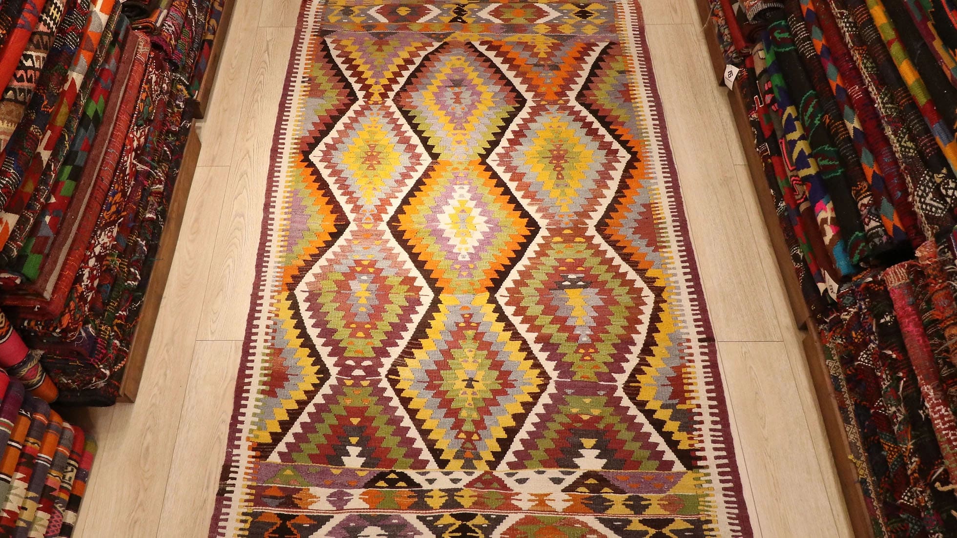 a magnificent Turkish rustic kilim rug in muted pastel tones and tribal patterns by Kilim Couture New York rug showroom 