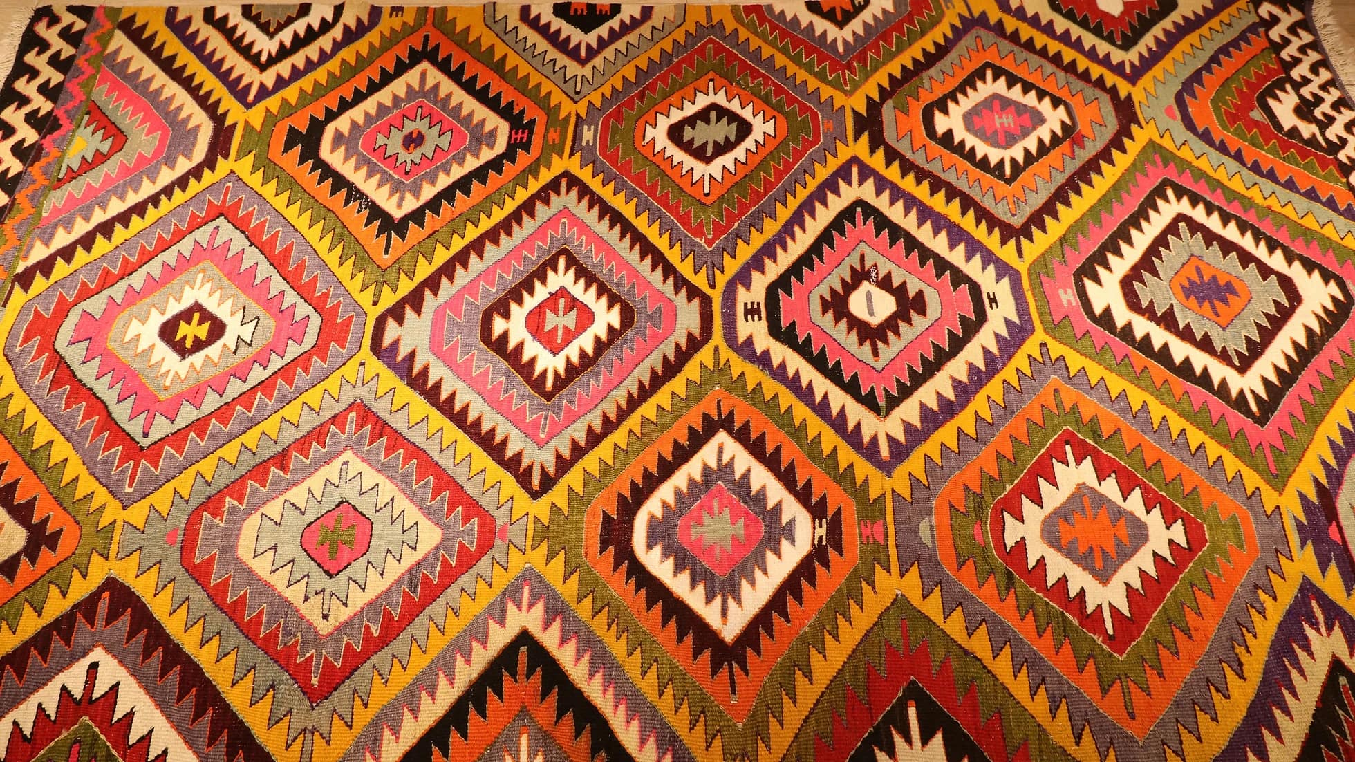 a magnificent mid-century Turkish tribal rug in bright and bold colors and geometric diamond patterns from Antalya