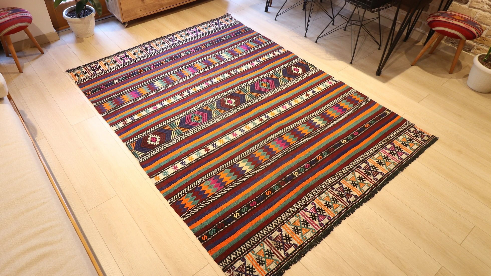 vintage Turkish handwoven kilim rug with vivid and vibrant colors, geometric stripes, and traditional motifs