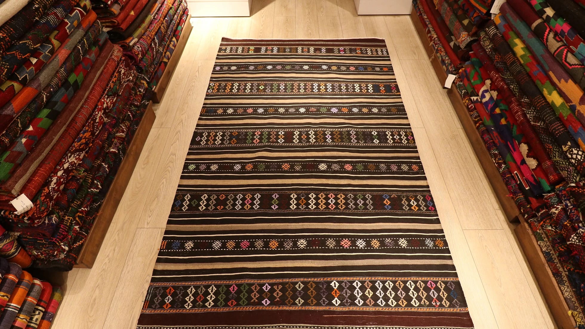 mid-century Turkish tribal flat-woven rug featuring pastel traditional Anatolian kilim motifs and stripes in brown and gold from Balikesir