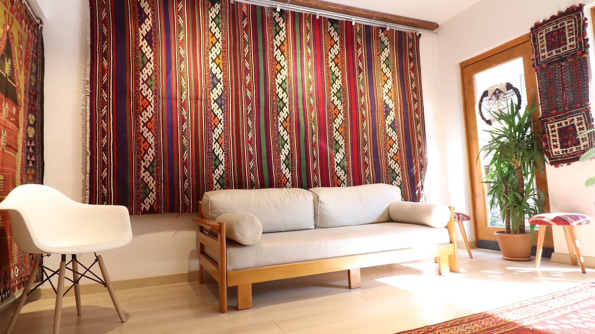 magnificent Turkish Balikesir kilim rug hand-knotted in the mid-century featuring colorful stripes and tribal style hanging on the wall as a tapestry