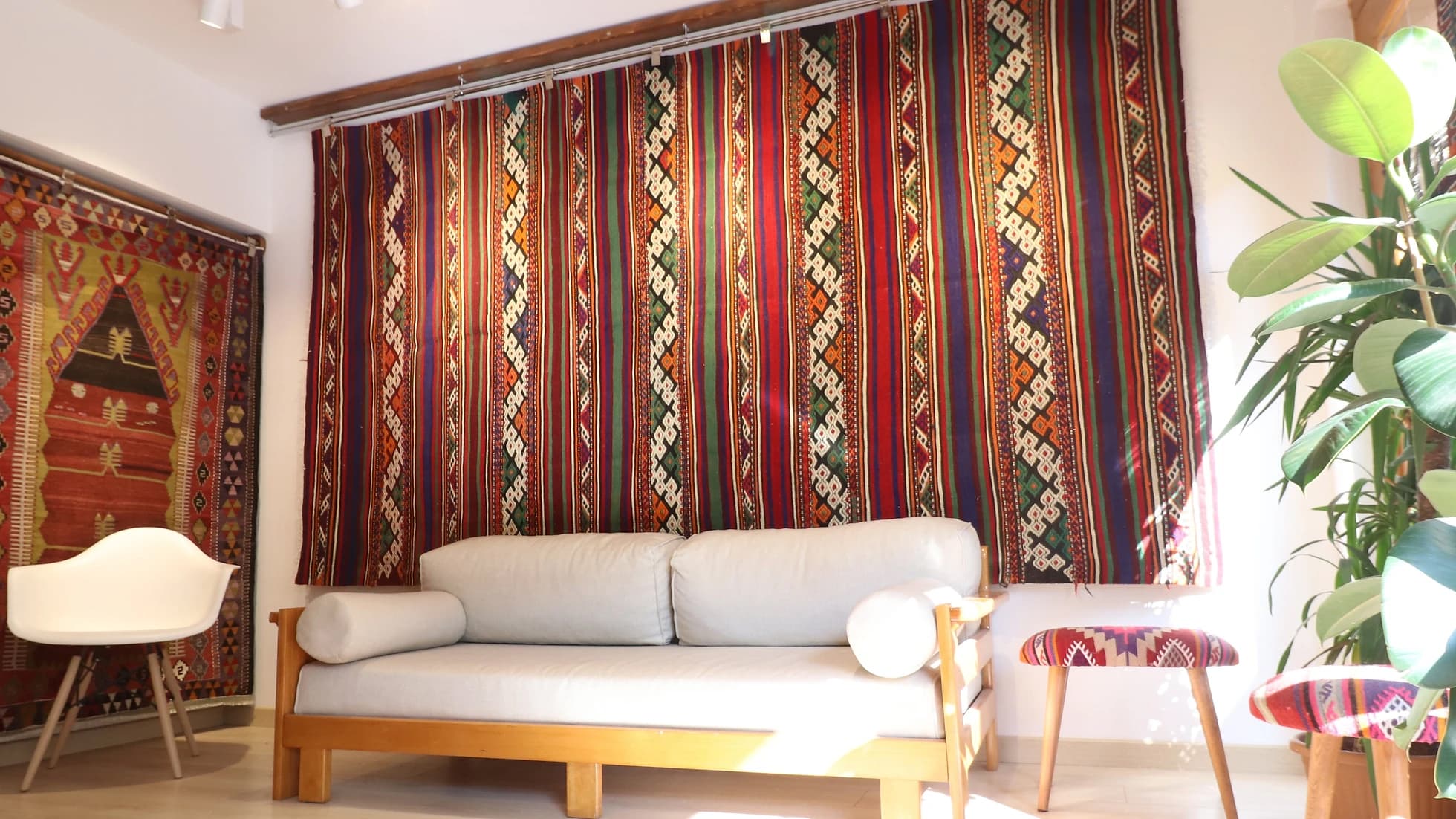 magnificent Turkish Balikesir kilim rug hand-knotted in the mid-century featuring colorful stripes and tribal style hanging on the wall as a tapestry