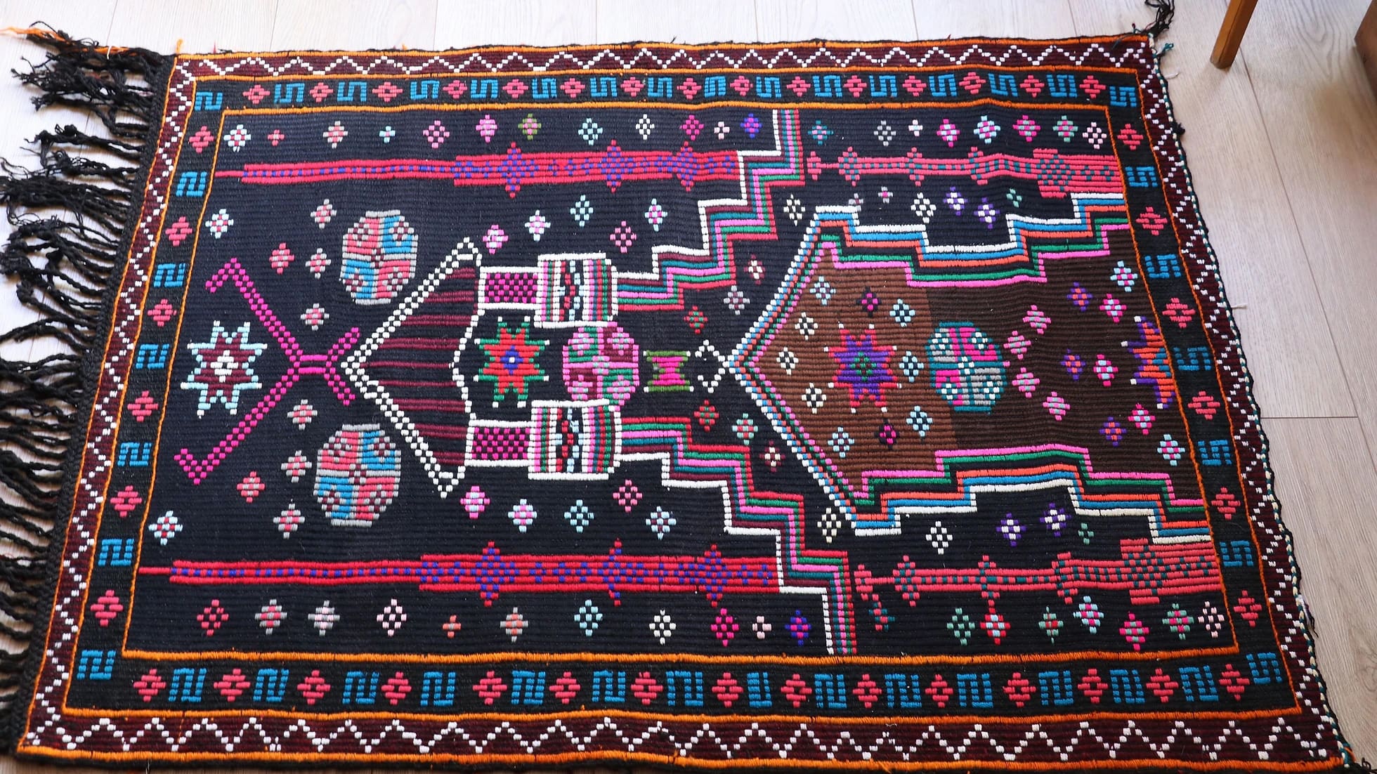 vintage handwoven Cecim Kilim prayer small area rug in gorgeous fuchsia and amethyst colors with black tassels in detail