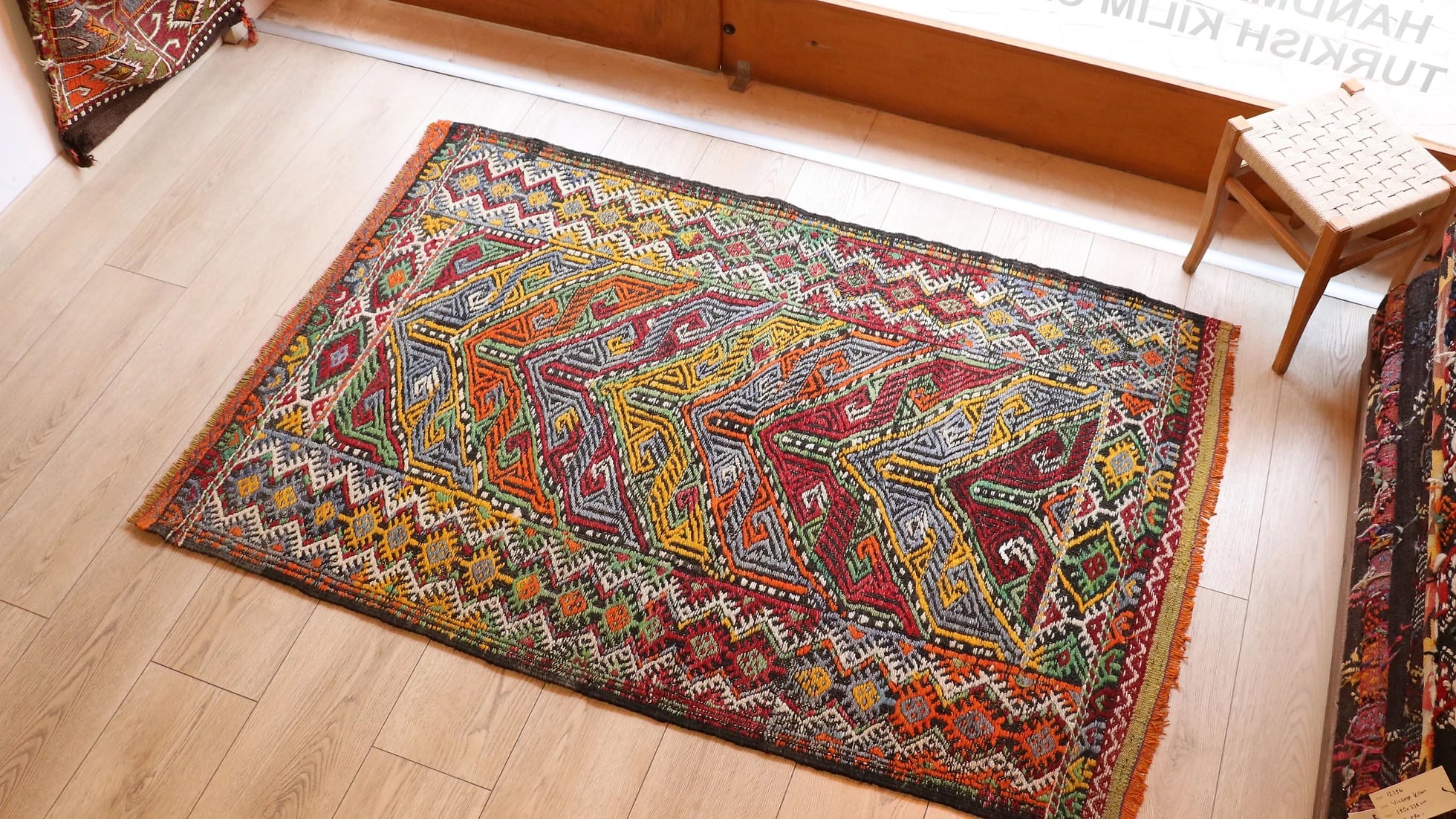 vintage mid-century Turkish rug from 1950s featuring traditional kilim motifs in many vivid and vibrant colors