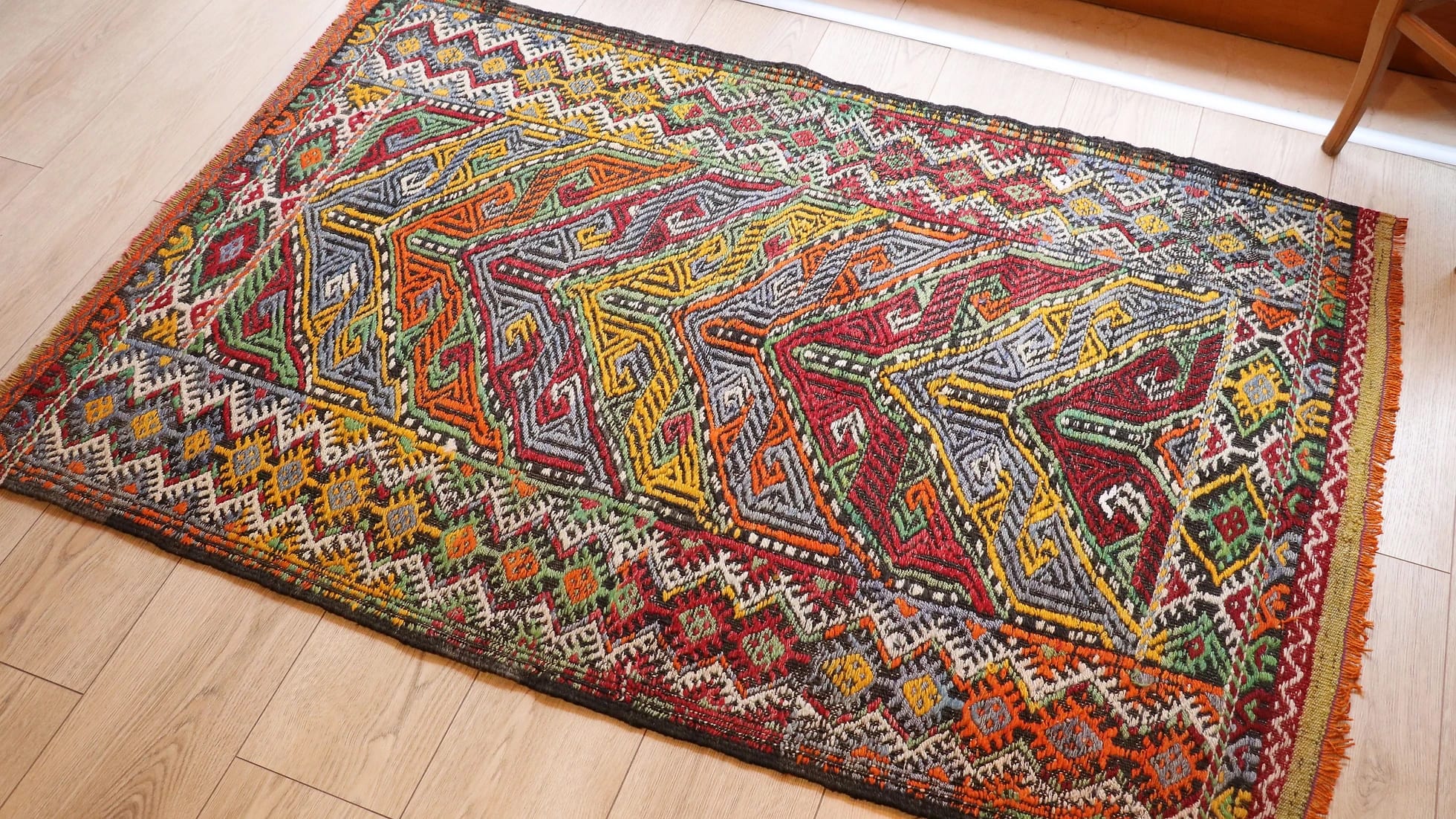 vintage mid-century Turkish rug from 1950s featuring traditional kilim motifs in many vivid and vibrant colors