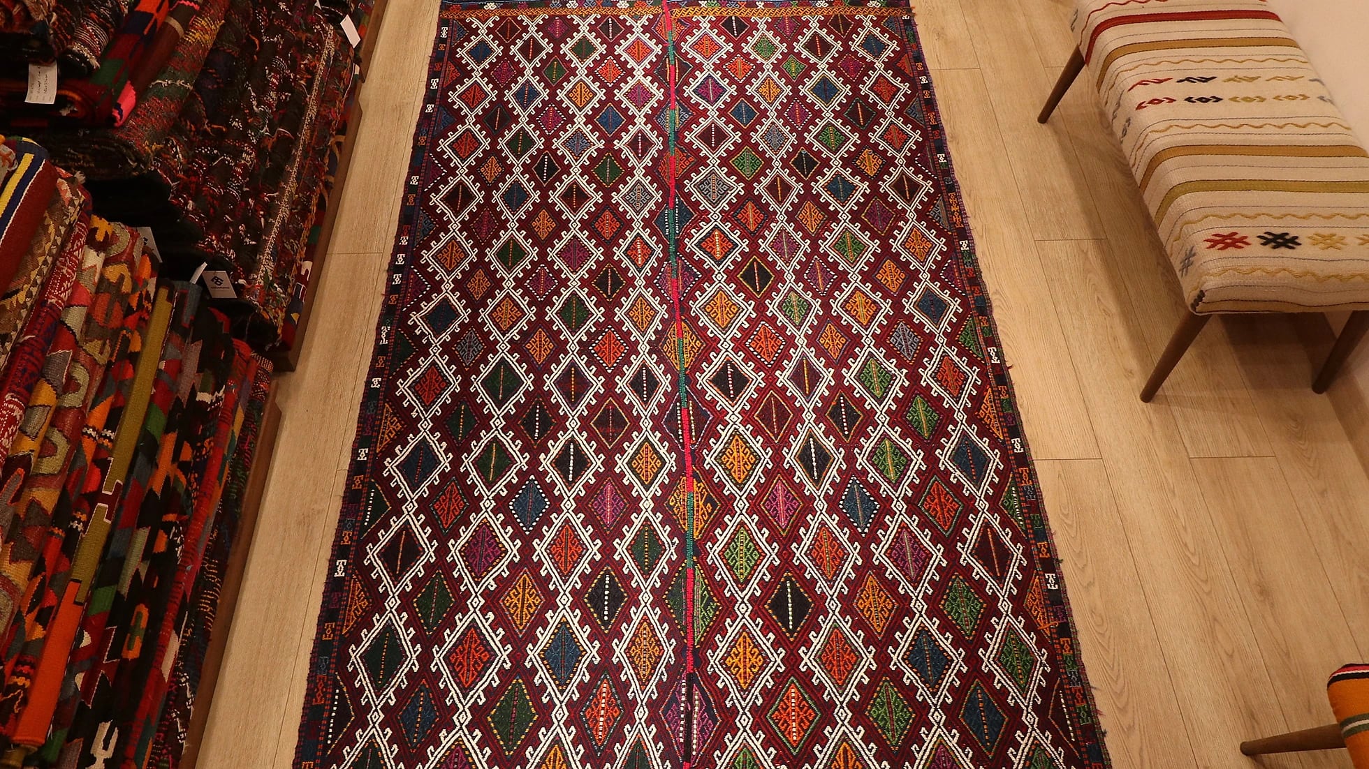 a perfect mid-century tribal Kurdish rug from Denizli, Turkey featuring traditional kilim motifs in muted and faded earth tones