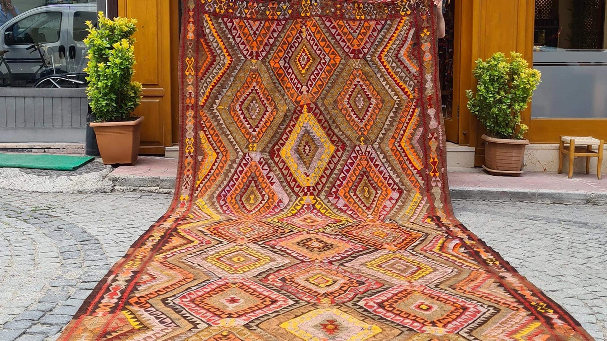 vintage handcrafted turkish tribal rug in yoruk style in saffron yellow and bronze orange from mid-century