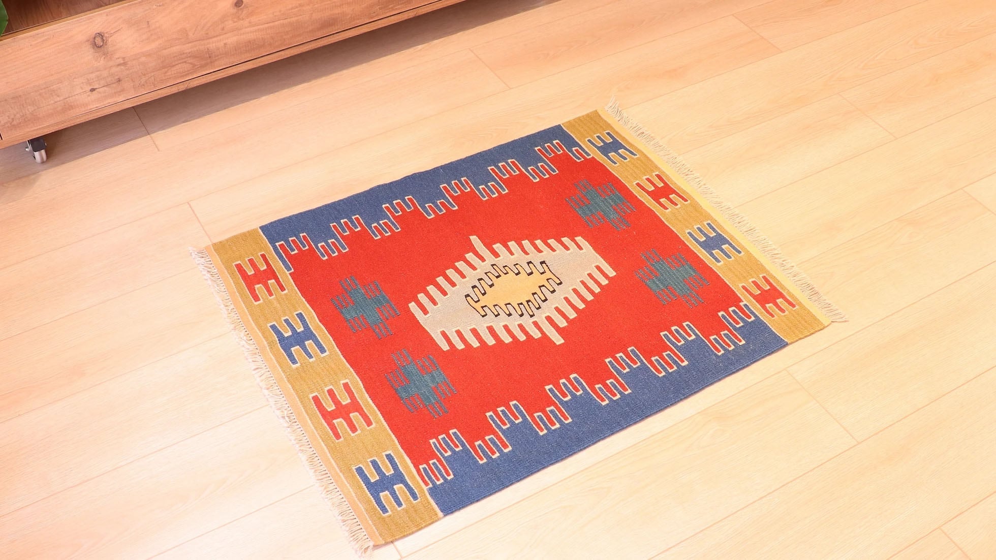 a small and captivating Ushak kilim rug in red, blue, and gold by Kilim Couture New York