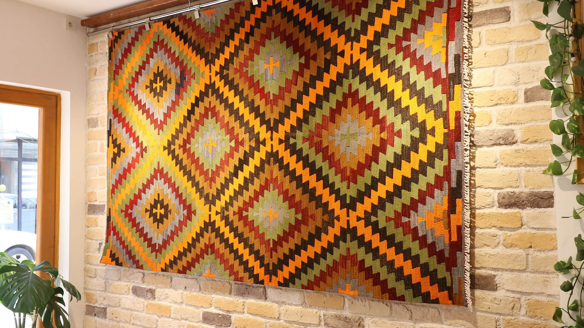 a 5x8 polychromatic luxury modern handwoven Turkish flat-woven rug in diamond and lozenge patterns