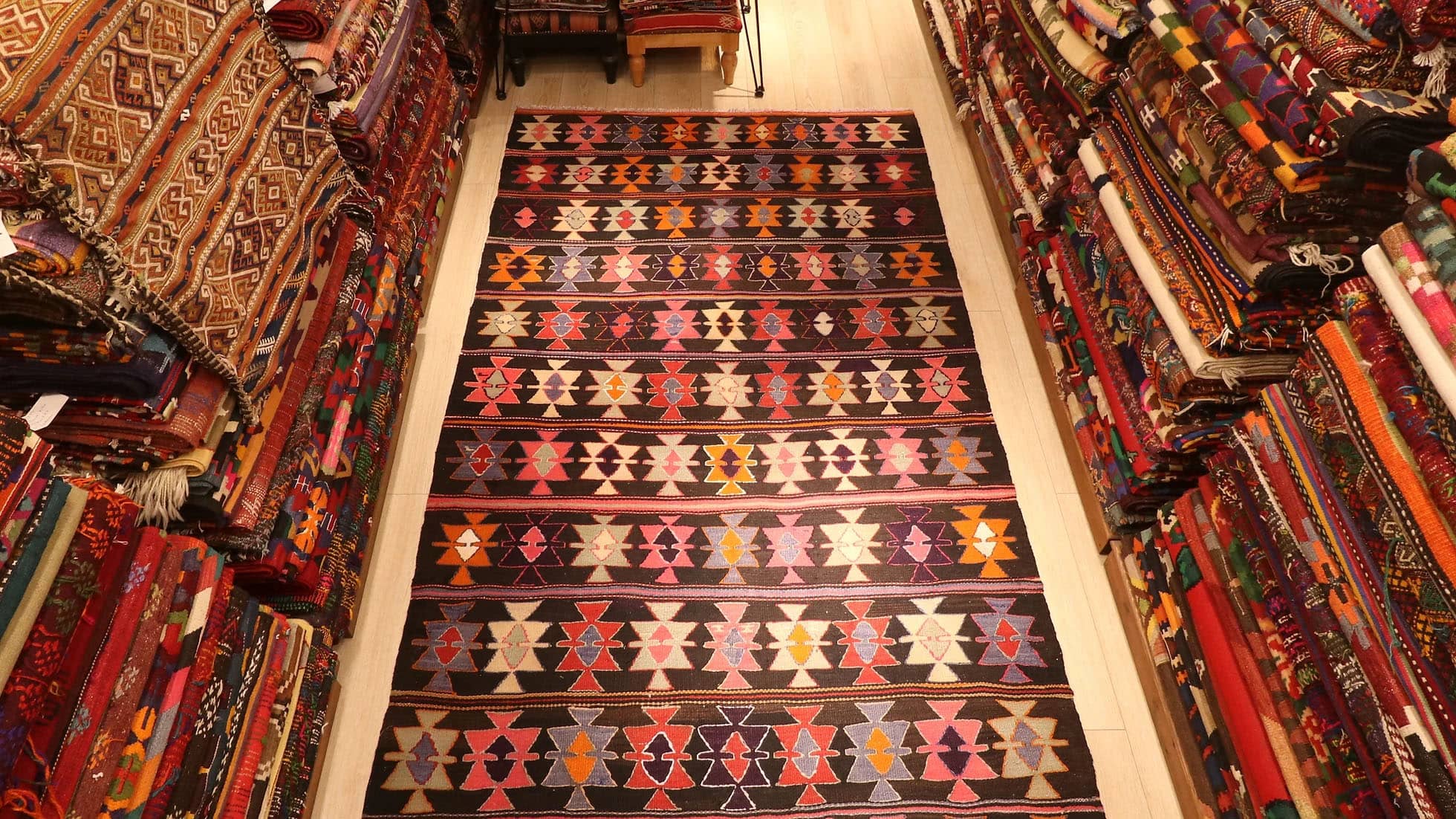 tribal and colorful maximalist vintage mid-century Turkish cecim kilim rug displayed at Kilim Couture New York rug gallery