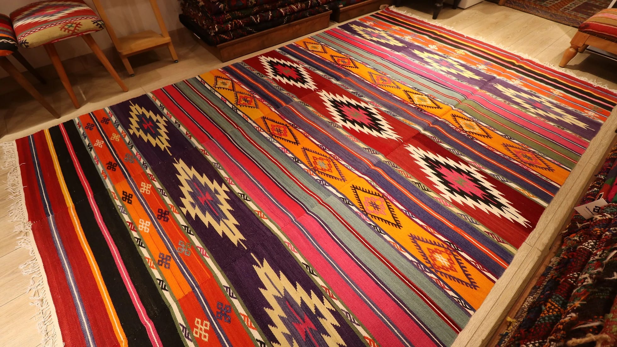 vibrant, vivid, and colorful striped Anatolian Turkish rug hand-knotted in the mid-century in traditional patterns